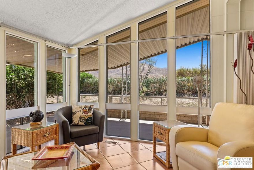 Dramatic mountain views enhance this open and light home behind the guarded entrance of Cathedral City's beautiful Date Palm Country Club. A free-flowing floorplan makes entertaining and daily living equally enjoyable in the single-level design, which features two bedrooms and two baths in approximately 1,536 square feet. A private side entry provides a welcoming introduction, leading to a spacious living room and a large dining room with built-in cabinetry and glass display shelving. Wrapped in floor-to-ceiling windows, the sitting room joins a large kitchen to create a great room-style setting with gorgeous views straight out to Mount San Jacinto. An island with bar-height seating takes center stage in the kitchen, where chefs of all skill levels will appreciate solid-surface countertops, white cabinetry with a built-in pantry, ample prep space, and a full suite of appliances including a gas cooktop. Bedrooms are comfortable and private, with the primary suite highlighted by an ensuite bath with two sinks, a soaking tub and separate shower. Vaulted ceilings lend an airy ambiance in every room of the home, which is appointed  handsome tile flooring throughout, ceiling fans and mirrored wardrobe doors. Outdoors, a large wraparound patio leads to a backyard with some of the best mountain views in the community. Enjoy a variety of mature fruit trees, a carport and a spacious shed/workshop. A popular choice among active adults 55 and better, Date Palm Country Club presents a carefree resort environment that features an 18-hole golf course, pro shop, large newly remodeled clubhouse, restaurant, three pools and spas, tennis and pickleball courts, a fitness center, dog park, library/meeting room, lush greenbelts and scenic lakes. The theaters, restaurants, shops and park in Cathedral City's revitalized downtown are moments from home, and Palm Springs and Rancho Mirage are just minutes away.