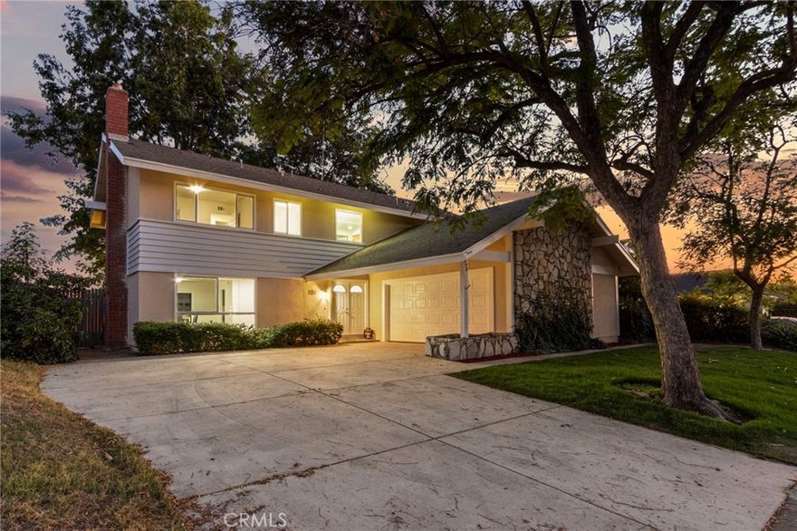 Welcome to this beautifully renovated 5 bedroom, 2.5 bathroom home in the heart of Brea. This spacious two story residence has been thoughtfully updated inside and out, offering modern comfort with timeless style. Step through the inviting double door entry into a light filled interior featuring new LVP flooring, recessed lighting, and fresh paint throughout. The sunken living room boasts a cozy fireplace and large windows that flood the space with natural light. A generously sized dining room opens through sliding glass doors to the newly landscaped backyard, perfect for indoor & outdoor entertaining. The chef’s kitchen is a true highlight with stainless steel appliances, stone countertops, custom cabinetry, and a window over the sink that frames the view. Adjacent to the kitchen, you’ll find an additional family room complete with a bar area and convenient laundry room. The updated powder bath rounds out the downstairs living space. Upstairs, a striking chandelier sets the tone as you discover five well sized bedrooms with new windows and ample closet space. The primary retreat includes an en suite bath and private patio, offering a peaceful escape. Outdoors, enjoy a brand new sod lawn, patio area, and fencing, creating a private space to relax or entertain. Brea Olinda Unified School District offers enriching Science, Technology, Engineering, Arts and Mathematics (STEAM) programs in elementary, junior high and high school. Located near Brea Mall, downtown shopping and dining, and easy freeway access, this home truly has it all.