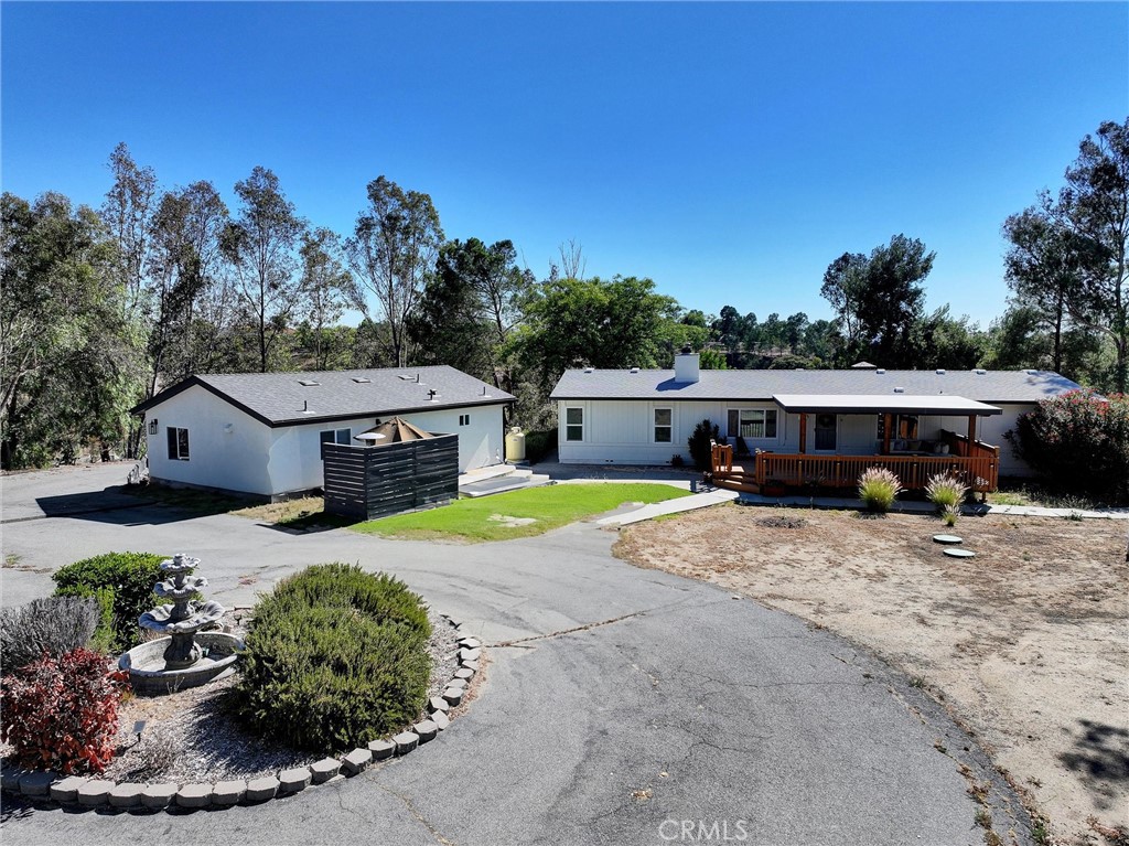 Enjoy the tranquility of country living just minutes from town and surrounded by Temecula’s premier wineries. This scenic 2.6-acre hilltop property offers 360-degree views, mature trees, and ample space for all your toys, horses, or future expansion. Zoned for a custom home over 5,000 sq ft, this is a rare opportunity to live comfortably now while planning for the future.
The newly remodeled main home features 3 bedrooms, an office, and 2 full bathrooms—including a spa-inspired master suite. Relax or entertain on the covered front and back decks, where you can enjoy peaceful mornings watching hot air balloons rise over wine country. The fenced yard offers both privacy and versatility for pets or outdoor living.
A fully permitted, brand-new stick-built ADU offers an open-concept layout with a full kitchen, living room, large bedroom, full bathroom, and laundry hookups. Perfect for multigenerational living, guest accommodations, or income potential—currently rented but can be delivered vacant. The main house is 1848 sq ft and the ADU is 600 sq ft.
This versatile property blends peace, potential, and proximity to all that Temecula has to offer. Don’t miss your chance to make it yours!