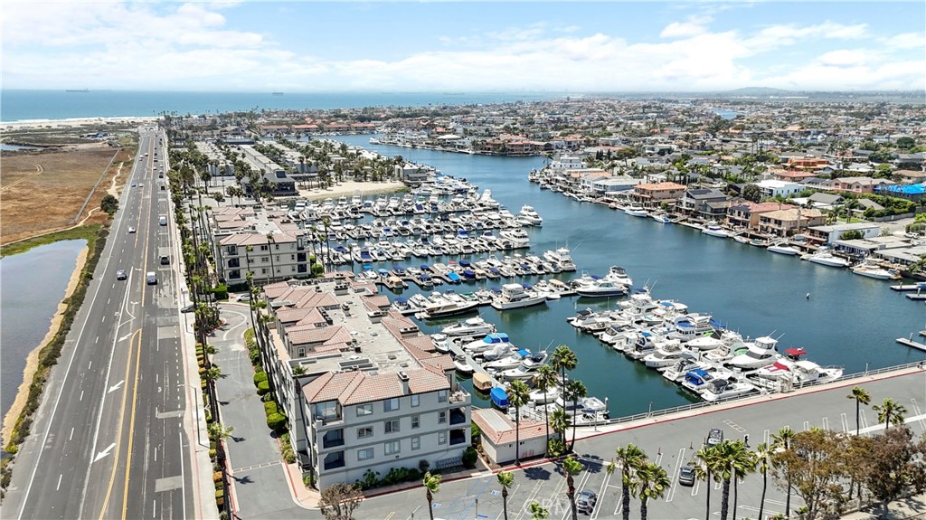 Fabulous opportunity," this best value for a Huntington Harbour waterfront condo with views of the harbour and views of the Bolsa Chica wetlands.
Completely Remodeled Coastal Condo in Huntington Harbour Bay Club. Experience luxury coastal living in this stunning single-level condo with panoramic views of the Huntington Harbour Marina and Bolsa Chica Wetlands. Located on the first floor of the sought-after Huntington Harbour Bay Club, this professionally designed and fully upgraded home offers an open floor plan that seamlessly blends style and comfort. Step inside to be greeted by breathtaking water views and a modern kitchen featuring quartz countertops, sleek cabinetry, a built-in stainless steel refrigerator, and a brand-new microwave and dishwasher. Adjacent to the kitchen is a formal dining area, perfect for hosting. The spacious living room with fireplace and cabinets opens to a private balcony, ideal for relaxing or entertaining while watching boats glide across the harbor. The primary suite is a peaceful retreat with a large picture window capturing endless harbor views. The remodeled en-suite bathroom boasts a soaking tub, a separate walk-in shower with custom glass enclosure, a dual sink quartz vanity, and a spacious walk-in closet. The secondary bedroom showcases views of the wetlands and even Catalina Island on a clear day, with an adjacent remodeled full bathroom featuring modern finishes. Additional highlights include: Brand-new washer and dryer -65" plasma TV, 2 additional brand new TV's all professionally hung with no cords showing. Convenient elevator access, Two gated parking spaces and storage cabinets in the subterranean gated parking garage. Located across from the elevator. The Huntington Harbour Bay Club community offers a resort-style pool and spa, and a beautifully renovated two-story clubhouse with a full kitchen, fireplace, and pool table. Just steps from the beach, restaurants, and shopping. Boaters will appreciate marina access within the community.