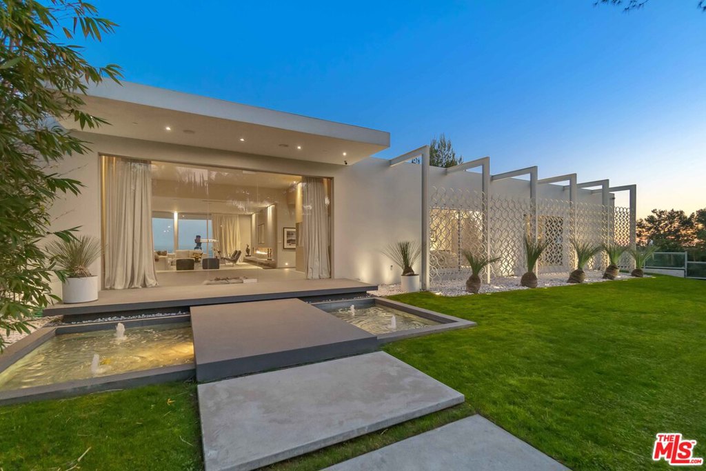 Perched upon the hillside of Trousdale Estates, enjoy one of the finest unobstructed 180 degree panoramic views in all of Beverly Hills. This vast tableau extends as far as the eye can see stretching from the skyline of downtown Los Angeles to Catalina Island. This can all be taken in from the infinity edge pool/jacuzzi as well as the master suite and most rooms in this open concept 5 bedroom modern villa. Welcome to Mid Century Modernism Redefined, a Steve Hermann design. His top down 2 year renovation was designed to take full advantage of the view and to perfect the blending of indoor and outdoor space. Wonderfully illuminated throughout via multiple skylights and towering walls of glass yet elegantly designed with all the luxury and modern accoutrements worthy of this prestigious neighborhood within one of the most desirable zip codes in the nation.