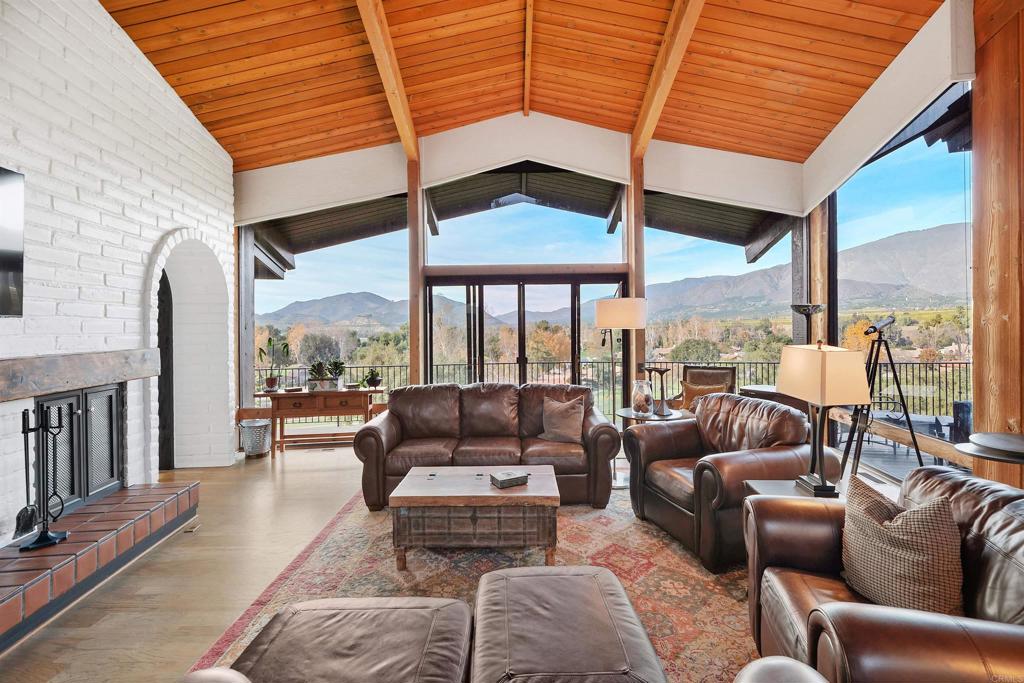 UNPARALLELED VIEWS IN SHANGRI-LA SETTING!! Experience breathtaking backdrops and pastoral scenery from every angle at this exceptional property fronting the 12th green of the Pauma Valley Country Club. Designed to capture magnificent views of Pauma Valley, the golf course, and the Palomar Mountain range, this nearly 2-acre corner lot offers a rare blend of privacy, potential, and prestige. Property Highlights • Prime Location: Golf course-fronted, elevated corner lot with two water meters in place. • Development Potential: Per owner discussions with San Diego County, the property may be split to sell acreage. Build an ADU, spec home, or create your personal outdoor oasis—perhaps even a romantic vineyard. • Historic Provenance: The Weir Brother Adobe home, designed by renowned architect Don Brandenburger, is eligible for a property tax reduction as a designated Historic Home. The Home A tiled walkway and charming patio surrounded by mature olive trees lead to a grand double-door entrance, where jaw-dropping views immediately bring the outside in. Expansive patios connect each main area of the home, linking the spaces seamlessly across the length of the house. • Main Kitchen: Features granite counters, custom cabinetry, and a tri-fold window with counters both inside and out. • Butler’s Kitchen: Equipped with butcher block countertops, SubZero freezer drawers, additional dishwasher, farm sink, and abundant extra storage. • Dining Room: Showcases soaring ceilings and a spiral staircase leading to a unique balcony—originally designed for opera singer Dorothy Kirsten to entertain guests, and rumored to have once hosted Frank Sinatra. Bedrooms & Suites • Primary Suite: Includes a private office with striking views through a 12-foot by 6-foot window, a luxurious ensuite bath featuring a large seamless glass shower, dual water closets (one with soaking tub), and ample mirrored closets. • Second Primary Bedroom: Offers an ensuite bath, private entry, and deck. • Detached Third Bedroom/Studio: Currently used as an office, this space includes a full bath, coffee bar, wine refrigerator, and a private covered patio with breathtaking views for guests. Additional Features • Workshop & Storage: Climate-controlled workshop and additional storage rooms are located beneath the walk-out portion of the home. • Energy Efficiency: Owned solar system (43 panels) provides little to no electric bill. • Security & Amenities: Located within the guard-gated, security-patrolled enclave of Pauma Valley Country Club—home to the acclaimed Robert Trent Jones Sr.-designed golf course (a Golf Digest Top 100 Club in the U.S. and Top Ten Club in California), and a private Air Park. Too many upgrades to list—interested buyers can request the full list. Square footage per appraisal; buyer to verify. This is a rare opportunity to own a piece of history, enjoy unparalleled privacy, and embrace the very best of Pauma Valley living. Pauma Valley Country Club is a private club. New Homeowners are welcomed to apply for Membership. Various Memberships are available.