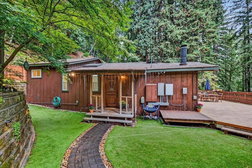 Discover your own slice of paradise in the Los Gatos Hills. This  enchanting property features 2 bedrooms plus office,  1.5 bathrooms and a separate studio, backing to pristine forest and trails. The light-filled living room features a dramatic wall of windows opening to a large, sunny deck, blending indoor/outdoor living.  Beautifully updated gourmet kitchen shines with custom wood cabinetry, a center island, new LG appliances, including a double oven and gas range, and a large walk-in pantry with washer and dryer.  The tranquil primary suite includes walk-in closet and a tiled shower bathroom. A second bedroom and dedicated office provide versatile space. Outside, you'll find a restored original mtn cabin for guests, art room gym or home office. Enjoy the private deck overlooking the lush forest and Los Gatos Creek, providing a serene escape and hiking into the watershed below. Home is equipped with a tesla power wall and has been updated throughout including new roof. Comcast internet available. Friendly community offers hiking trails, a playground, and a clubhouse.  Prime location minutes to downtown LG, close to Lexington Reservoir, with best Los Gatos schools featuring Lexington Elementary (International Baccalaureate Program), Fisher Middle and Los Gatos High.