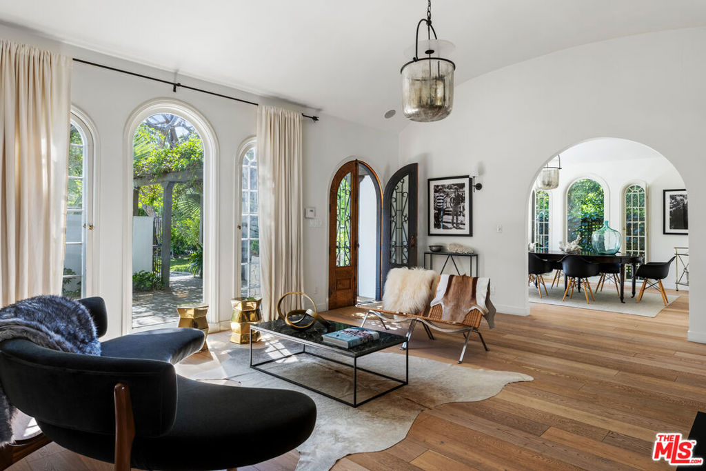 Step into paradise every time you come home to this authentic 1920's Spanish oasis. Respected architect, Marc Appleton, lived in this home and further enriched its design, adding his personal touches. The property is gated, with tall hedges creating privacy, and is located in the tranquil and secluded streets North of Sunset in Brentwood. The main house exudes romance and character, with 4 bedrooms, 5.5 bathrooms, formal and informal dining rooms, several living spaces and a home office. Primed for entertaining, the open plan kitchen leads out to a courtyard perfect for al-fresco dining under the stars. Architectural features include barrel ceilings, arched windows and doors, exposed wooden beams, and charming fireplaces. The primary suite has a pitched ceiling, two walk-in closets, dual bathrooms, fireplace and sauna. A lush utopia awaits through the French doors into the garden, complete with mature trees, pool, spa, fire pit, and fountains. The detached guest house at the rear of the grounds is accessed via a private walkway, with a bedroom, bathroom, lounge and kitchenette. This impeccable home is truly a haven amidst the hustle & bustle of Los Angeles.