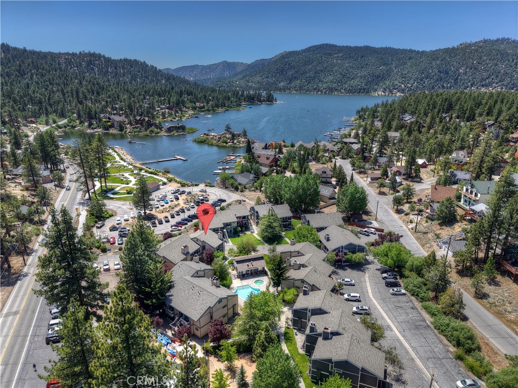 Charming lakeside condo with direct access to the lake and Boulder Bay Park, featuring excellent views of lake, national forest and pool. This upper-level unit features its own private staircase—no shared access—making it one of the few and most desirable in the complex. Recently updated and freshly painted, this home features two spacious en suite bedrooms, large windows, abundant natural light, multiple balconies and unfinished attic that offers potential for additional living space or storage. The easy accessible and landscaped complex includes a pool and hot tub for year-round enjoyment. Prime lakefront location, walking distance to kayak and paddleboard rentals, public transit, restaurants, stores and park, and the popular Castle Rock hiking trail less than a mile away. Excellent rental potential and an affordable way to enjoy lakeside living!