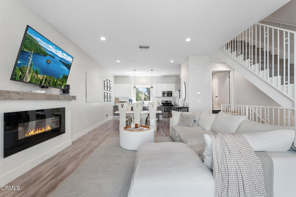 Experience upscale single-family living in this beautifully designed three-story home, built in 2015 and located in the heart of Collintine Modern--a gated community of 26 residences offering both privacy and security--nestled in the sought-after Valley Glen neighborhood.The ground floor provides direct access to a spacious two-car garage with an EV charger and features a cozy den--perfect for a home office, gym, or additional living space.On the main level, enjoy open-concept living with a bright and airy living room, dining area, and modern kitchen with a central island. This floor also includes a laundry room, guest bathroom, and a private balcony.The top floor features all three bedrooms, including a spacious primary suite with a walk-in closet and an ensuite bath with dual sinks and a shower, as well as a shared bathroom for the secondary bedrooms.Notable upgrades include hardwood floors, energy-efficient windows, a tankless water heater, pre-wired DVR/camera system and pre-wiring for solar panels.This property is located within the boundary of the Distinguished Chandler Elementary School, just half a mile away--making it a perfect option for families seeking quality education nearby.The gated community also offers secured guest parking and is conveniently located near Sherman Oaks Park & Recreation Center, Westfield Fashion Square, Trader Joe's, restaurants & shops.Note: Property is incorrectly shown as facing Hazeltine Ave on Google Maps, Zillow, and Redfin. It is actually located at the back of the community, away from the main street. Check listing aerial photos for reference.