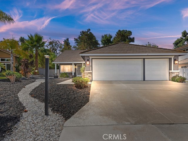Welcome to this charming and thoughtfully updated single-level home, tucked away on a peaceful cul-de-sac in the highly sought-after Paloma Del Sol community. No rear neighbors. Step inside to discover a bright and open floorplan featuring vaulted ceilings and an abundance of natural light from numerous windows.
Charming home with front porch and open floor plan. Durable tile flooring throughout the main living areas and carpet in the bedrooms. Off the entry, you’ll find a formal living and dining room that flows effortlessly into the spacious kitchen and family room.
The kitchen is a standout with its bright white cabinetry, granite countertops, large pantry, breakfast nook, and bar seating. The family room is anchored by a tile-accented fireplace and looks out onto the greenery of the private backyard.
Enjoy the outdoors in the low-maintenance backyard, complete with a spacious concrete patio, mature trees, and backs up to greenbelt with no rear neighbors. Down the hallway are four bedrooms, two full bathrooms, and convenient access to the attached 3-car garage.
The primary suite is a peaceful retreat with vaulted ceilings, a ceiling fan, walk-in closet, and an en suite bath. Best of all, enjoy Temecula’s 4th of July fireworks show right from your backyard!
Paloma Del Sol offers incredible amenities including pools, spas, parks, playgrounds, walking trails, and picnic areas. All just minutes from excellent schools, shopping, and dining. Fantastic location!
