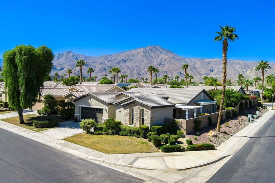 Perched on an 8,276sqft. premium corner lot, this beautifully appointed Monterey plan with detached Casita offers the perfect blend of comfort, style, and resort living in the heart of Trilogy at La Quinta. Featuring 3 bedrooms, 3 bathrooms, and a versatile den/office with its own private entry, this 1939 sq. ft. single family residence is designed to maximize both indoor and outdoor living. The Tuscan-inspired exterior, enhanced with stone accents and a custom wrought iron gate, opens into a serene private courtyard (with pergola) that seamlessly extends your living and entertaining space. Inside, soaring ceilings, gorgeous 20'' Italian tile flooring, and expansive picture windows create a bright and inviting ambiance. The chef's kitchen is equipped with upgraded cabinetry, a walk-in pantry, extensive granite counters and backsplash, stainless steel appliances including double ovens, gas cooktop, counter depth fridge, and a generous center island, with bar seating, making it ideal for cooking and entertaining alike. The open concept great room showcases a cozy tile encased gas fireplace and TV/Media niche. The spacious primary suite boasts plantation shutters and slider to rear yard, and guest accommodations, including the separate Casita, ensure comfort and privacy for family and visitors. Outdoors, the lush backyard features a paver deck, mature lemon and lime trees, providing a private oasis. Additional upgrades include a fully replaced A/C and HVAC system (2022) and 26-foot-deep garage. Great proximity to the Santa Rosa Clubhouse with its world-class amenities, this home offers the quintessential desert resort lifestyle. Schedule your private tour today!