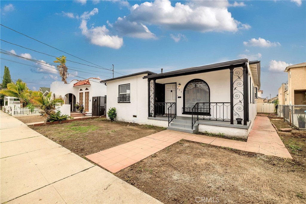 Opportunity Knocks on 17th Street in San Pedro! This charming Spanish-style home is full of character and potential. From the graceful rounded front window and curved archways to the newly refreshed hardwood floors in the living, dining, hallway, and bedrooms, it blends classic charm with room to make it your own. The home was recently painted inside and out and has a great layout, with a roomy living and dining area, a separate kitchen, and a super cute breakfast nook or bonus room with built-in cabinets. The bedrooms are down the hall, along with a nicely updated full bathroom. Notable upgrades include a tank-less water heater, updated plumbing and electric. Don’t miss the separate laundry room and fully-owned solar panel system for long-term cost savings. Add your personal touches and landscaping imagination, and you’ll have a great single-family home with a street-to-alley lot. A detached garage with alley access adds extra value and even more potential.