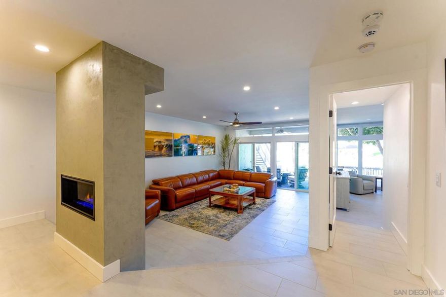 This furnished gorgeous waterfront end Condo is located in the exclusive Coronado Cays community, across from Silver Strand State Beach, where you may find yourself strolling in the early sunrise hours, catching some waves, enjoying the acrobatic kite surfers and dolphins who frequent the local surf break or taking a sunset stroll with your loved ones. Coronado Cays is located close to Loews Coronado Bay Resort and Hotel del Coronado. Coronado has an excellent variety of restaurants and is just a bridge away from many San Diego attractions for your family. This unique downstairs 1650 sq ft corner unit sleeps 6 and features stunning updated decor, with 2 beautifully decorated bedrooms and 2 full baths. You will find premium Thermador appliances in the kitchen (including a gas stove) with a new washer/ dryer in the unit. The self-contained waterfront patio is equipped with a propane BBQ, a large outdoor dining table which seats 8 people and a cozy firepit. The living room boasts a state-of-the-art remote gas fireplace, automatic window shades and a sectional leather sofa from which you can watch programs on an 85" television. Other amenities include 1 covered carport space, a 32' boat dock, a community pool and jacuzzi, new AC, and automatic shades in the master suite (with adjustable beds) and a walk-in closet. This end unit condo affords a private, luscious side greenbelt and an enclosed private front patio. This is the perfect place to relax, get away from it all and to enjoy a vacation with your whole family. Rates may vary depending on the season and length.