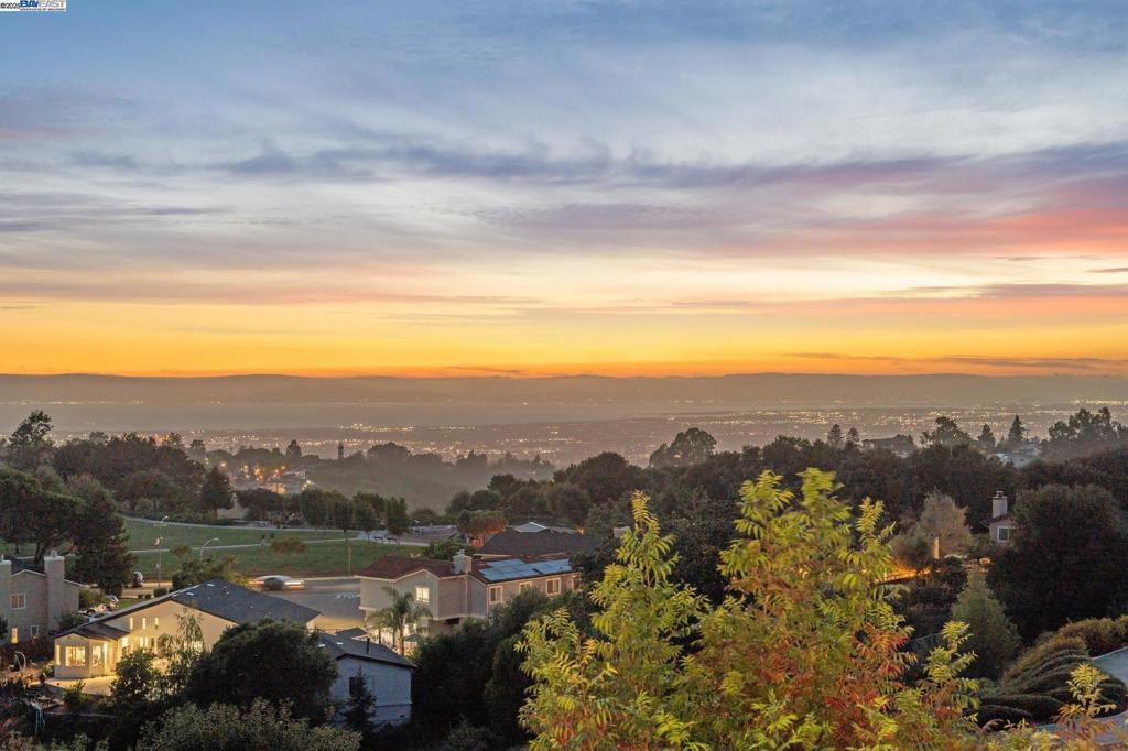 Welcome to the highly desirable Bailey Ranch residence tucked away on a quiet court, offering breathtaking panoramic views of the Bay. This expansive home features 5 bedrooms and 3 full bathrooms, including a bedroom and full bath on the main level, ideal for guests or extended family. The upgraded kitchen is a chef’s dream, featuring sleek quartz countertops, stainless steel appliances, maple cabinetry, and a spacious Brazilian stone center island, ideal for both gatherings and everyday living. The kitchen opens seamlessly to the inviting family room, which flows out to a serene backyard with no rear neighbors. Designed for enjoyment and ease, the low-maintenance yard features artificial lawn, a custom putting green, a spacious Trex deck, and a storage perfect for both entertaining and relaxing in your own private retreat. Modern upgrades include paid-off solar panels, a battery backup system, Andersen windows, and more, providing energy efficiency and peace of mind. Ideally located near Stonebrae Country Club, Stonebrae Elementary School, BART, public transportation, and major freeways, this home offers the best of comfort, convenience, and community. Don’t miss this exceptional opportunity to own a view home in one of Hayward’s most sought-after neighborhoods!