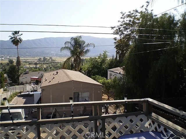 Welcome to 32851 Mesa Drive, a beautifully maintained triple-wide manufactured home nestled in the scenic hills of Lake Elsinore. This spacious 1,876 sq ft residence offers 2 bedrooms and 2 bathrooms, with the potential to convert the generous family room into a third bedroom. Situated on a permanent foundation, the home boasts ownership of the land, eliminating space rent feesUpon entering, you'll find a dedicated office area adjacent to the laundry space and pantry, leading into an open-concept kitchen equipped with a breakfast bar. The seamless flow continues into the dining, living, and family rooms, culminating in a vast wrap-around deck that provides breathtaking views of the surrounding mountains and Lake Elsinore. This outdoor space is perfect for entertaining or enjoying serene sunsets