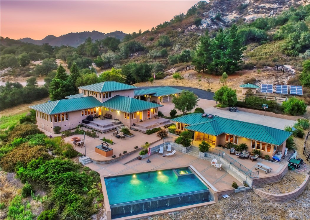 Elegant Estate on 21+ Acres with Infinity Pool and Custom Finishes
Set on over 21 acres of serene countryside, this elegant custom-built estate offers refined living with thoughtful details throughout. The main residence features 4 bedrooms and 4 baths, including two spacious suites—ideal for multi-generational living or guests.
A chef’s dream, the gourmet kitchen boasts a flour and sugar drawer, a sliding cabinet pantry, veggie sink, double oven, and expansive counter seating for up to eight. Dining room ideal for gatherings. It opens seamlessly into a spacious great room adorned with custom maple cabinetry, a warm fireplace, and built-in window seat storage with surround sound—perfect for entertaining or quiet nights in.
Two bedrooms are located on the main level, while the luxurious upstairs primary suite offers added privacy. Every bedroom is outfitted with custom built-in desks and dressers for a clean, integrated feel.
The separate pool house includes one bedroom and two bathrooms, providing a private retreat for guests or extended stays. Outdoor living shines with a solar-heated infinity pool, built-in BBQ, fire pit, and lush surroundings.This home is thoughtfully designed for comfort, utility and elegance.
Detached power room with backup generator and solar battery system. Built-in storage throughout for optimal organization. This one-of-a-kind property offers privacy, comfort, and the space to live, work, and play in style.