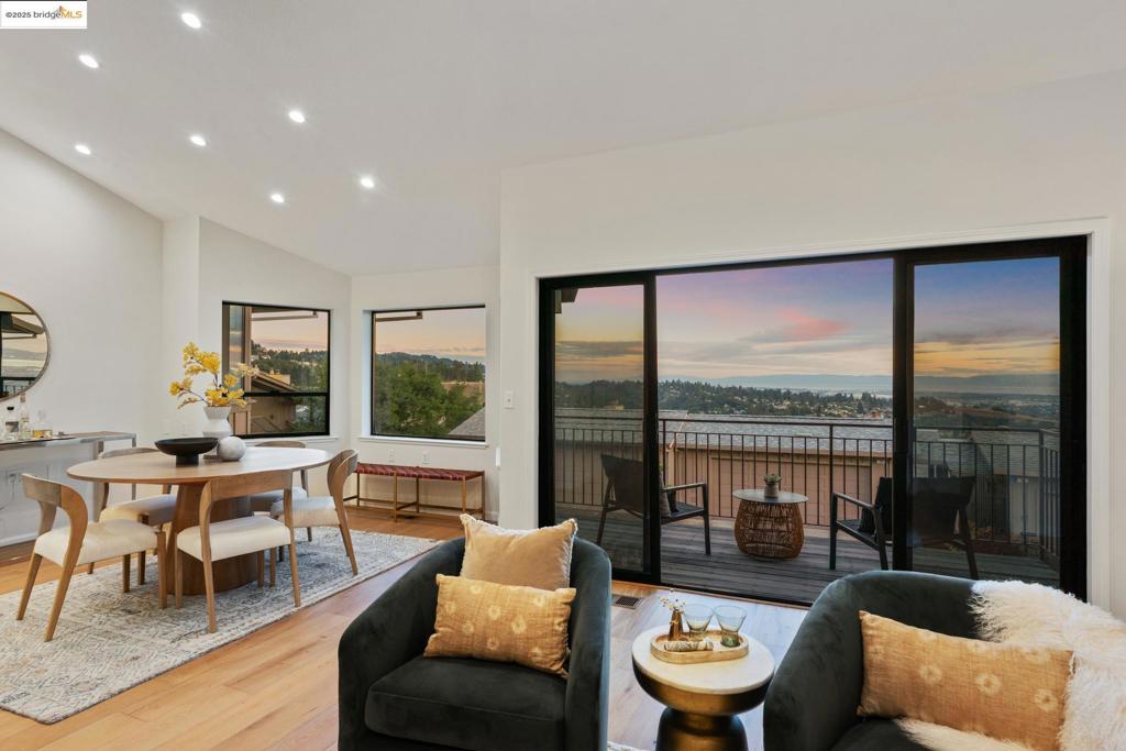 This beautifully updated townhome in the desirable Hiller Highlands community offers the perfect blend of comfort, style, and breathtaking views—from San Francisco to the Peninsula, including the iconic Oakland skyline. The open floor plan features engineered Oak floors, soaring ceilings and a wall of windows that fill the home with natural light. Enjoy the outdoors from the view deck or relax by the wood-burning fireplace in the inviting living room. The modern kitchen includes quartz countertops, a custom backsplash, and flows seamlessly into the dining area—ideal for entertaining. The spacious primary suite features a second fireplace and a luxurious en-suite bath with a dual-head walk-in shower, marble picket-fence tile, a double vanity, and ceramic tile flooring. Downstairs offers two bedrooms, an updated full bath, and a large private patio shaded by a mature Oak tree, plus a separate entrance—perfect for guests or flexible living. The two-car garage with interior access adds convenience and generous storage. With stunning design, natural beauty, and an unbeatable location, this home is a rare find in the East Bay. Views: Downtown