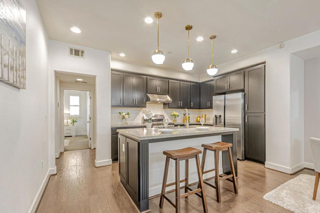Less staircase & more open space. End unit! This beautiful & stunning 3 bedroom + Den/Office space + 2 bath home is located in the heart of Silicon Valley, offering comfort, style, and unbeatable convenience. Built in 2014 with many upgrades, it features a highly desirable floor plan w/ minimal stairs and thoughtful design throughout. Enjoy an open-concept layout with a gourmet kitchen showcasing granite countertops, a large island with large sink, marble backsplash, cherry wood cabinetry, and elegant hardwood floors. Dual vanities, a private patio/balcony, modern light fixtures, walking closet, high end stainless appliances and recessed lighting throughout. Designed for energy efficiency and year-round comfort with dual-pane windows, central A/C & heating, a tankless water heater. Recent upgrades include fresh paint. laundry room, attached garage, and excellent proximity to freeways. Short walk Great Mall, BART, Light rail, Mattos School, Trader Joes, Starbucks, dining, retail, and a brand-new community park w/ modern playgrounds, open green space, picnic areas, and walking paths. Highly sought-after school district with nearby schools rated on GreatSchools: Mattos 10/10 for test scores), Rancho Middle School ( 9/10 for test scores), and Milpitas High ( 9/10 for test scores).