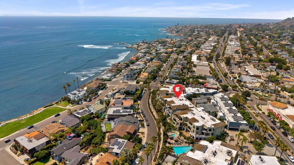 Experience the best of coastal living at Seahaus, an upscale retreat nestled in the heart of Bird Rock. This exceptional west-facing ocean-view residence offers two spacious bedrooms plus a versatile third room, ideal for a home office, guest space or creative studio. Located just steps from local cafes, shops, upscale dining, Calumet Park and the ocean, this desirable Breakers unit features a large patio and grassy area that capture gentle breezes and a partial ocean view. Here, La Jolla living shines at its most relaxed and refined.This single-story ground level unit offers a functional open floor plan and a host of recent updates, including new luxury vinyl flooring, a new A/C unit, built-in refrigerator, washer and dryer, and a new water heater. It also features travertine flooring, plantation shutters and energy-efficient fixtures throughout.The gourmet kitchen opens seamlessly to the living and dining areas, where a cozy fireplace adds warmth and charm, perfect for both entertaining and everyday living. The versatile den has been thoughtfully upgraded with a custom Murphy bed and built-in storage cabinetry, making it ideal for guests or a productive home office. The luxurious primary suite offers a spacious bedroom retreat with a spa-like bathroom and generous closet space. This unit includes two side-by-side garage parking spaces and a private storage space. Seahaus is a resort-style community offering a pool, spa, gym, BBQ area and beautifully landscaped grounds, all just a block from the beach. Don’t miss the chance to own this move-in ready home in one of the most sought-after coastal communities.