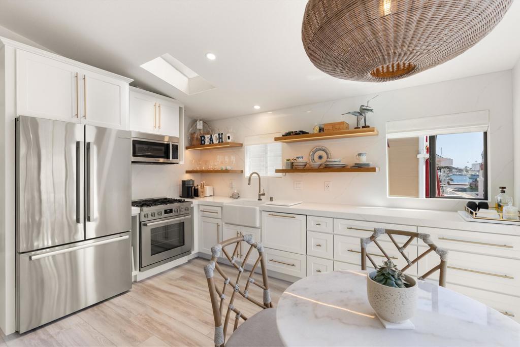 Stunning Beach Cottage in exclusive Lido Peninsula Resort - Your Dream Coastal Retreat Awaits! Welcome to Newport Beach living at its finest. This fully remodeled beach cottage is the turnkey getaway you've been waiting for. Designed with style and sophistication, no detail was overlooked in this exquisite renovation. Step inside to discover luxurious custom finishes, including: Sleek Quartz countertops, Elegant backsplash, Rich white oak floating shelves and Beautifully crafted cabinetry throughout. The chef's kitchen is a showstopper, featuring top-of-the-line Bosch appliances that combine performance with modern design. Enjoy water views from your dining area--perfect for serene mornings and vibrant sunsets. The cozy fireplace adds warmth and charm for cool coastal evenings, while remote-controlled window coverings offer both privacy and convenience with the touch of a button. The spa-inspired bath features designer finishes, creating a peaceful sanctuary right at home. Move-in ready - just bring your flip-flops!Resort Amenities (included with monthly land lease of $3,463/month): Private beach access, Pool & spa, Clubhouse, Gym and very Low property taxes. Steps to fine dining, shopping, and entertainment. Whether you're looking for a full-time residence or a weekend getaway, this home is more than just a property--it's a lifestyle. Ready to live your coastal dream?Welcome home to Lido Peninsula.