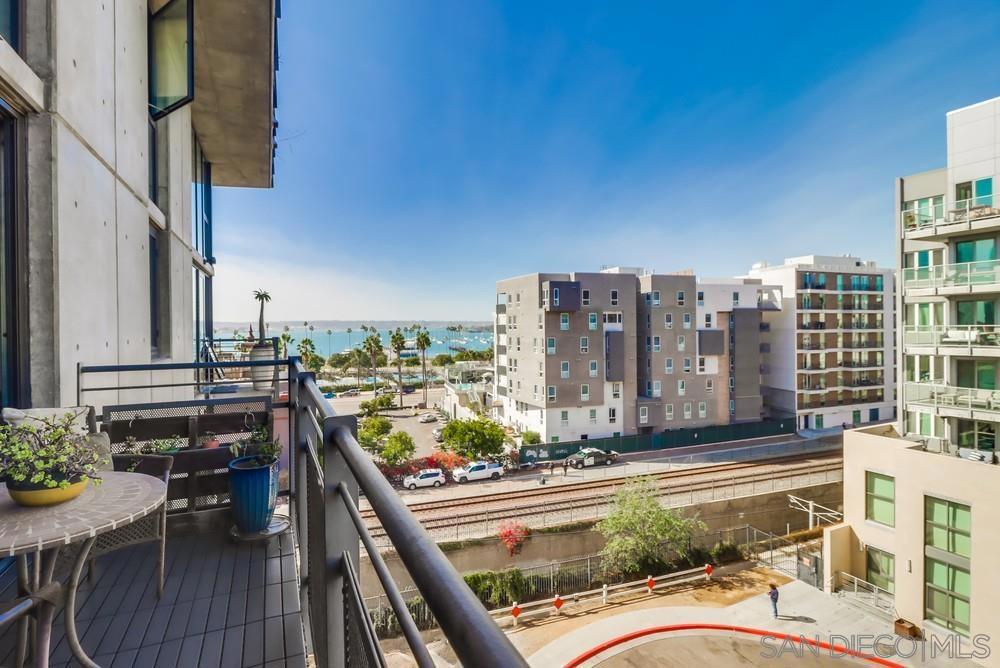 Come and see this freshly painted, spacious, light and bright 2 story loft with den/optional 2nd bedroom located on the 5th floor. Experience the luxury of living in the downtown life in Little Italy. It has amazing 18ft floor to ceiling panoramic doors that open up to views of the harbor. Large patio to step out on and have a cup of joe in the morning or enjoy a nice of wine as the sun sets. Home has wood flooring, granite kitchen countertops, open floor plan, 2 secured underground parking spaces (remote key access), primary room is a loft ensuite, exposed concrete interior, lots of natural light, close to all, enjoy the weekly Farmer's Market and fine dining all within walking distance. Lobbyand hallways all with new carpet. HOA included water, trash, part time front door concierge, gym and rooftop access to BBQ's and lounges (UPDATE wine color paint has been painted white in unit)