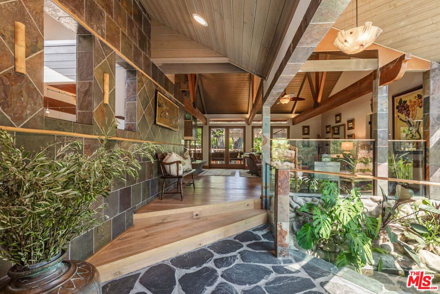 Welcome to 1064 Meadows End A One-of-a-Kind Architectural Sanctuary in Monte Nido's Coveted Malibu Canyon Neighborhood.Tucked at the end of a quiet cul-de-sac and framed by ancient sycamore and oak groves, this beautiful single-level architectural home offers a rare blend of refined design and natural beauty. Set on just over an acre of flat, park-like grounds, this property is a true staycation retreatprivate, peaceful, and surrounded by nature.Step through the serene entry with black flagstone pavers complete with a koi pond, and into an expansive, light-filled interior crafted with meticulous attention to detail. French Oak floors flow throughout, while dramatic wood-beamed ceilings and a striking four-sided fireplace anchor the open-concept living space. A wall of French doors seamlessly connects indoors to the entertainer's dream backyard, flooding the home with natural light and bringing the outside in.The chef's kitchen is a statement in both function and formfeaturing concrete countertops, top-tier appliances with double oven, warming drawer, ice machine, Sub Zero Refrigerator & Freezer, two dishwashers and custom cabinetry complete this fabulous kitchen. Skylights illuminate the adjacent dining area. A flexible floor plan offers 4 bedrooms, and 4 bathrooms ensures optimal privacy for guests, with well-separated secondary bedrooms. The newer primary suite is a sanctuary of its own, offering custom built-in cabinetry, soaring ceilings, French doors that welcome morning light, and a luxurious bath with a soaking tub and heated floors. A step-down family room leads out to a spectacular pool oasis designed by renowned landscape architect Nick Williams, complete with a rock waterfall and lushly landscaped surroundings. Back 4th bedroom could serve as additional den / office with oversized closet / art or hobby room. And unique rock wall 3/4 pool bathroom opens to outdoor shower and private garden.Wander through flowering gardens and along meandering paths beneath majestic oak trees. Enjoy a rose garden, fruit trees and charming chicken coop, and plenty of flat usable landperfect for outdoor entertaining, quiet reflection, or simply soaking in the beauty of this magical setting.Additional features include 3 tankless water heaters, Dual Zone HVAC system, new Generator 2024 and a new roof in 2025.Ideally located just minutes from Malibu Creek State Park's hiking trails, the vibrant restaurants, shops and beaches of Malibu. Calabasas Commons, and the 101 Freeway. Situated in the award-winning Las Virgenes School District, this is not just a homeit's a lifestyle.A rare architectural gem where nature meets design. A truly magical retreat.
