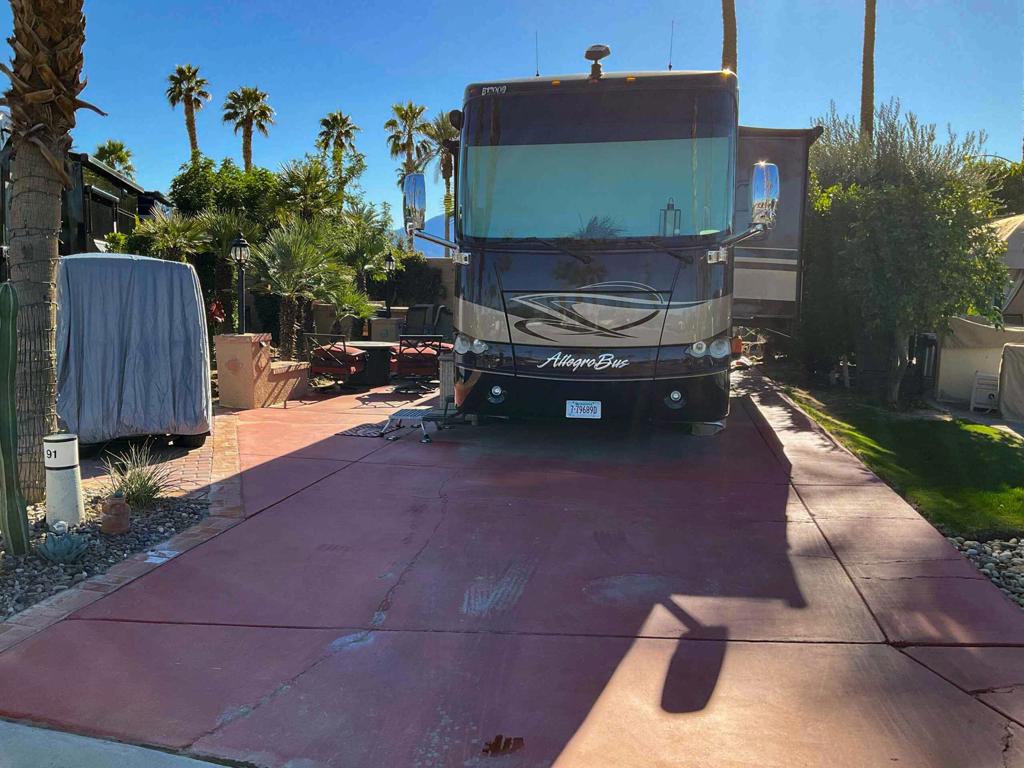 This spacious, pie-shaped luxury RV lot in Phase 1 offers an ideal east-facing orientation, providing beautiful morning sun and comfortable afternoon shade--perfect for enjoying the outdoors in style. Designed to accommodate a 45-foot coach with ample space for a potential casita, this lot is conveniently located near top-tier resort amenities, including golf, tennis, pickleball, bocce ball, and a nearby satellite pool with a hot tub and laundry facilities. Thoughtfully upgraded with new pavers and featuring a grassy backyard, it's a pet-friendly haven offering both relaxation and functionality.The well-equipped outdoor kitchen is a delight, boasting a gas BBQ, two-bar sink, cooktop, water heater, and a premium sub-zero refrigerator and freezer. Entertain effortlessly in the elegant outdoor dining area, complete with a large cantilever umbrella and a stylish glass dining table that seats eight. Cozy up in the inviting seating area with four swivel rocker chairs and a tabletop fire pit, creating the perfect ambiance for evening gatherings. As an added bonus, a Yamaha golf cart is included at full price offer, making it easy to explore the resort in comfort and style. This exceptional lot offers a blend of luxury, convenience, and resort living at its finest.‍‍