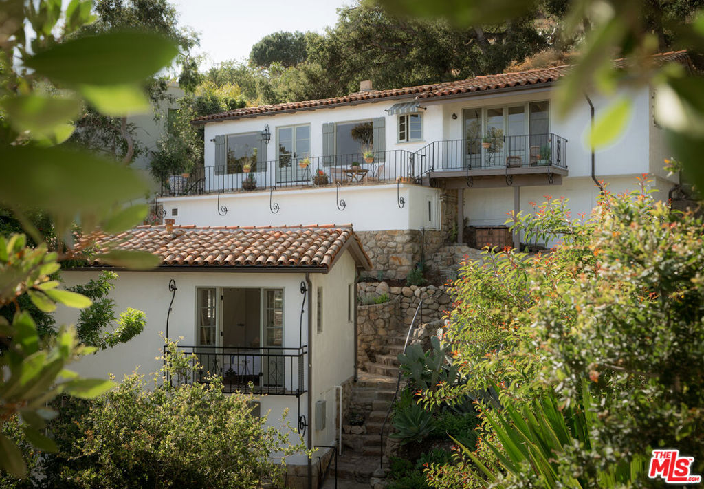 Positioned along one of the most iconic view corridors in Santa Barbara, this is a rare opportunity two romantic 1920s villas on the Riviera. Set across 1.37 acres of meandering gardens, private patios, and ocean-facing terraces, this soulful compound offers breathtaking views from sunrise to sunset - spanning the city, coastline, harbor, and islands beyond. Lovingly restored with intention and artistry, each villa is steeped in character and charm. Original stonework, red-tile roofs, hand-painted tiles, and vintage ironwork nod to the past, while updated kitchens, curated finishes, and thoughtful touches bring effortless livability into the present. The main house opens to a dramatic living room with vaulted wood-beamed ceilings, a carved stone fireplace, and expansive views that feel cinematic in scale. A marble - clad kitchen and sun-drenched bedroom suite flow seamlessly to a romantic terrace - ideal for morning coffee or golden hour gatherings. The second villa echoes the same sense of style and serenity, offering a private retreat for guests or a potential income opportunity.Winding stone paths connect a series of lush outdoor spaces - secret seating areas, a view-drenched pergola, and gardens designed for reflection and restoration. The result is a transportive sense of place - one that feels worlds away yet sits just minutes from the energy of downtown Santa Barbara. Historic. Soulful. One of one.
