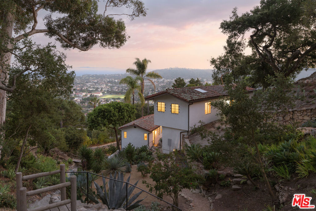 Positioned along one of the most iconic view corridors in Santa Barbara, this is a rare opportunity two romantic 1920s villas on the Riviera. Set across 1.37 acres of meandering gardens, private patios, and ocean-facing terraces, this soulful compound offers breathtaking views from sunrise to sunset - spanning the city, coastline, harbor, and islands beyond. Lovingly restored with intention and artistry, each villa is steeped in character and charm. Original stonework, red-tile roofs, hand-painted tiles, and vintage ironwork nod to the past, while updated kitchens, curated finishes, and thoughtful touches bring effortless livability into the present. The main house opens to a dramatic living room with vaulted wood-beamed ceilings, a carved stone fireplace, and expansive views that feel cinematic in scale. A marble - clad kitchen and sun-drenched bedroom suite flow seamlessly to a romantic terrace - ideal for morning coffee or golden hour gatherings. The second villa echoes the same sense of style and serenity, offering a private retreat for guests or a potential income opportunity.Winding stone paths connect a series of lush outdoor spaces - secret seating areas, a view-drenched pergola, and gardens designed for reflection and restoration. The result is a transportive sense of place - one that feels worlds away yet sits just minutes from the energy of downtown Santa Barbara. Historic. Soulful. One of one.