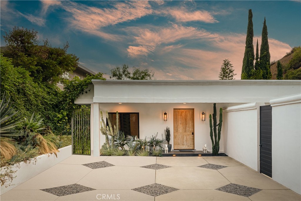 Perched on a serene cul-de-sac just above Sunset Boulevard in the coveted Bird Streets, this meticulously redesigned single-story residence blends high-end luxury with effortless indoor/outdoor living. Spanning approximately 2,300 sq ft on an expansive 8,400+ sq ft lot, the home features 3 bedrooms, 4 bathrooms, and a versatile den, all thoughtfully laid out for comfort and entertaining. Inside, a sun-filled open floor plan adorned with high end finishes, custom Parisian wall coverings, recessed lighting, and designer details throughout. The gourmet kitchen boasts top-of-the-line Miele appliances and sleek marble countertops, flowing seamlessly into the formal living room with an elegant statement fireplace. The spacious primary suite offers a custom closet, spa-like bathroom with a walk-in steam shower, spa tub, sauna, and dual custom vanities. Each bathroom has been exquisitely upgraded with luxurious materials and finishes. Outdoors, the beautifully landscaped flat backyard features a sparkling pool and patio space perfect for entertaining, all set against tranquil treetop canyon views. Additional highlights include state-of-the-art surround sound, security camera system, and newly painted interiors. Rare for the area, the property includes a gated private driveway with 4 parking spaces. Ideally located just minutes from the Sunset Strip, Soho House, Sunset Plaza, and Beverly Hills, this Hollywood Hills gem offers style, privacy, and convenience in one stunning package.