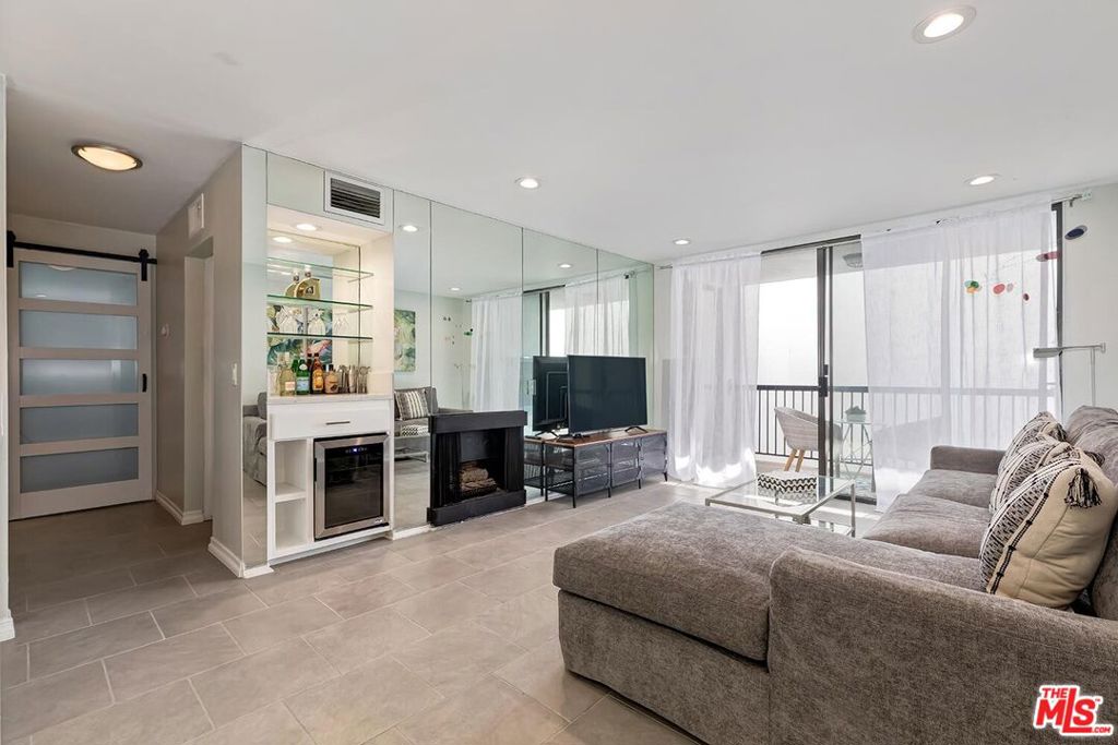 Step into luxe West Hollywood living, just moments from Beverly Hills. This beautifully remodeled 1bed, 1bath condo in the Norma Triangle is drenched in natural light. The living and dining areas flow effortlessly into a sleek new kitchen, showcasing stainless steel appliances and Quartz countertops. Imagine cozy evenings by the fireplace, sipping a drink from your builtin bar with wine fridge. Both the spacious primary suite and main living area open onto a private, generous balcony with views of the pool, a serene backdrop for morning coffee or evening relaxation. The building spoils you with resort style amenities: a heated pool, rejuvenating sauna, and fully equipped gym. And when you venture out, you're mere minutes from the vibrant shops, restaurants, and nightlife along Sunset and Santa Monica boulevards. Don't miss your chance to discover urban tranquility and unbeatable convenience today.