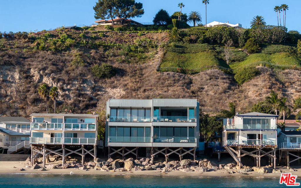 Discover unparalleled coastal living in this beautifully updated 3-bedroom, 2.5-bathroom oceanfront condo located at 22822 Pacific Coast Highway, Malibu, CA 90265. Spanning 1,956 square feet, this residence offers breathtaking panoramic views of the Pacific Ocean, including both sunrises and sunsets, as well as vistas of the iconic Malibu Pier.The condo has undergone significant modern enhancements, blending contemporary design with classic coastal charm. The open-concept living area is adorned with floor-to-ceiling windows, ensuring that natural light and ocean views are integral parts of the interior ambiance.The gourmet kitchen is equipped with high-end stainless steel appliances, quartz countertops, and custom cabinetry, making it a chef's dream. Adjacent to the kitchen, the dining area seamlessly flows into the living space, creating an ideal setting for both intimate dinners and larger gatherings.The primary suite serves as a private retreat, featuring a spacious layout, en-suite bathroom with spa-like amenities, and direct access to a private balcony overlooking the ocean. The second bedroom is equally inviting, with ample closet space and easy access to a well-appointed guest bathroom.Additional amenities include in-unit laundry facilities, secure parking, and access to community features designed to enhance the coastal living experience.Situated in a prime Malibu location, residents are just minutes away from renowned dining, shopping, and entertainment venues. Whether you're seeking a serene beachfront sanctuary or a stylish space for entertaining, this condo offers the best of Malibu living.