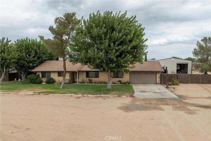 Charming custom horse ranch featuring a 2,000 sq. ft. metal workshop with full power—plus exceptional outbuildings and move-in ready living. The home has been thoughtfully rehabbed over the years with a new roof, updated HVAC, new windows, new flooring, recessed LED lighting with dimmers and fresh paint. Interior highlights include updated baths (the hall bath features a soaker tub), a master suite with barn-style door and large walk-in closet leading to the master bath, and a refreshed kitchen with quartz counters, refinished cabinets, recessed lighting, pull-out pantry shelves and a
 new stove. A pellet stove in the living room provides additional warmth, and a spacious enclosed sunroom—currently used for a pool table—also includes a pellet stove. The 2,000 sq. ft. metal workshop has full power and two roll-up doors, ideal for equipment, vehicles or a workspace. Additional ranch amenities include a barn with capacity for approximately 100 bales of hay, a playhouse, a relaxing spa that stays, and a concrete slab ready for a splash pool. Property landscaping and utilities include two almond trees, black walnuts, and plum, a 14-zone irrigation system, a dog run, replaced and stained fencing with new gates, and a septic tank with a riser installed. The garage area offers a hobby/storage room, 240V electrical, water softener, two tankless water heaters and a reverse osmosis system under a sink. This property qualifies for USDA financing. Please verify with your lender.
