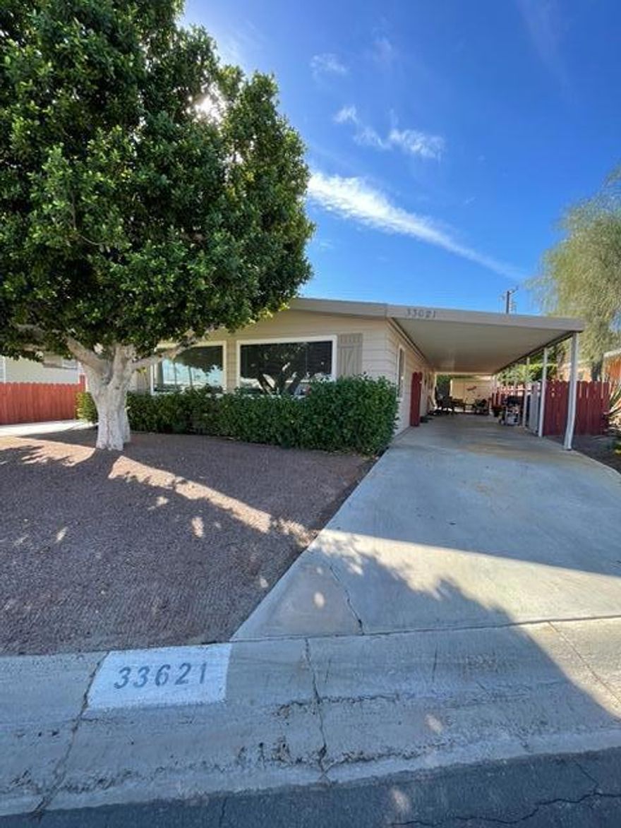 Stylishly Updated Home Where You OWN the Land!Welcome home to this beautifully refreshed 2-bedroom, 2-bath gem in the desirable Tri Palm Estates & Country Club. Step inside to find new flooring, fresh paint, and updated lighting and plumbing fixtures that give the home a bright, modern feel. The open layout flows effortlessly from the spacious living room--with picture windows that flood the space with natural light--to the dining area and cozy family room with sliding doors to the covered patio. There's even a dining bar at the attractive kitchen island. The updated kitchen and baths blend style and functionality, while both bedrooms feature generous walk-in closets. The home is partially furnished with tasteful decor and includes all appliances, making your move easy and stress-free.Enjoy the convenience of a gated carport, ample parking, and an inviting backyard ready for your personal touch.Best of all, Tri Palm Estates is an active 55+ community where you own the land and enjoy unlimited free golf on two beautiful courses. Take advantage of resort-style amenities--pools, spas, tennis, pickleball, shuffleboard, and a clubhouse with a restaurant, bar, and social events. Ideally located near Costco, Home Depot, Agua Caliente Casino, Eisenhower Medical Campus, Acrisure Arena, and just minutes from Palm Springs and Palm Desert dining, shopping, and entertainment.Move-in ready, beautifully updated, and packed with amenities--this one checks every box!