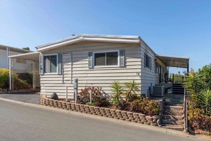 3 bedroom / 2 bathroom VIEW property in Family park w/ NO age restrictions!  Home has many improvements including an upgraded island Kitchen, updated Bathrooms, floors, refinished walls, fixtures, and more!  Lovely open floor plan with plenty of natural light and views from many windows!  This elevated lot offers a breezy covered porch, open air patio, and private yard in addition to a spacious storage shed and covered carport that easily fits 2-3 parked cars.  Note: There is no built in closet in the 3rd bedroom but the wardrobe conveys.  The refrigerator is negotiable depending on the offer terms, and all other appliances convey.  Rancho San Marcos park offers a clubhouse, pool, spa, ample guest parking, and is located right across from Richland Elementary.  Located in the San Marcos School District and walking distance to the newly remodeled Richland Elementary!  Space rent is $1,057.18 per month + utilities.