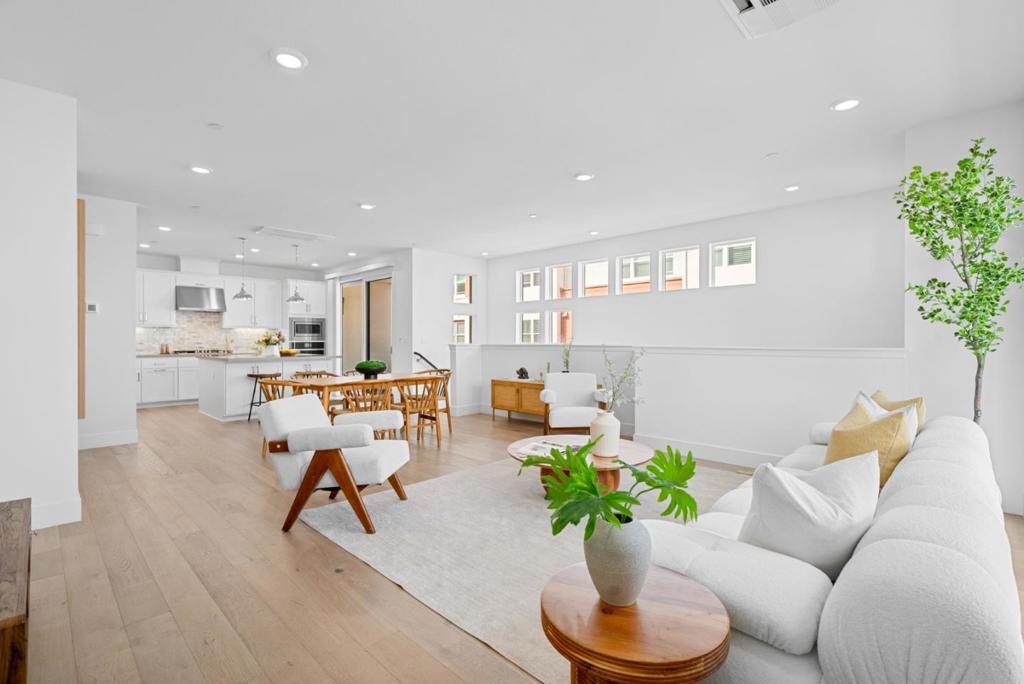 RARELY AVAILABLE FLOOR PLAN - BEST LOCATION IN NUEVO! Built in 2020, this modern townhome offers 1,924 sqft of beautifully finished living space with 3 bedrooms, a private office/den, and 2.5 bathrooms - a flexible layout designed for work-from-home professionals and growing families. Step into bright, sun-filled interiors with soaring 11-foot ceilings and expansive windows. The chefs kitchen features stainless steel appliances, quartz countertops, shaker soft-close cabinetry, and statement pendant lighting over a large island - ideal for everyday living and entertaining. Upgrades include VENETA cordless blinds, wide-plank hardwood floors, a whole-home water softener, and a sleek half-wall stair design that adds safety and a clean, modern look. The attached EV-ready 2-car garage also features a separate storage room, perfect for bikes, seasonal gear, or hobby space. Enjoy the Nuevo lifestyle with a clubhouse, dog park, playgrounds, basketball court, and outdoor gathering spaces. Bike to NVIDIA or Qualcomm, pick up groceries at Costco and Whole Foods, or hop on Lawrence Caltrain for a smooth Silicon Valley commute. This home is move-in ready, low-maintenance, and a smart long-term investment in one of Santa Claras most desirable communities.