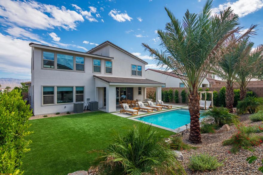 Move right into this stunning upgraded  4-bedroom, 3.5-bath pool home in the new University Park community, completed February 2025. This upgraded residence showcases mountain views, soaring ceilings, and abundant natural light throughout. The open-concept great room seamlessly connects the kitchen, dining, and living areas--perfect for entertaining. The gourmet kitchen features double ovens, a 5-burner cooktop, premium countertops, designer backsplash, and a spacious pantry.Enjoy true indoor-outdoor living with a private central courtyard and covered patio overlooking the large pool, mature landscaping, and custom lighting.Thoughtful layout includes one bedroom and 1.5 baths downstairs, plus three bedrooms, two baths, and a loft upstairs. The primary suite offers a walk-in closet, dual vanities, soaking tub, and large walk-in shower.Additional highlights:Upstairs laundry room with ample storage, Owned solar system for energy savings,Roman shades & scratch-resistant vinyl flooring and Upgraded pebble-finish garage floor.Residents enjoy The Grove, University Park's resort-style amenity center with pools, pickleball courts, a fitness center, event lawn, fire pit, and BBQ area.Experience modern luxury and resort-style living in this move-in ready Palm Desert gem!