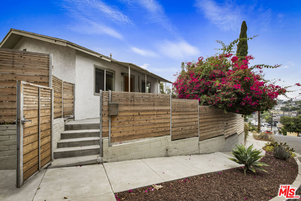 This jewel-box bungalow is the ideal spot in the highly coveted Garvanza pocket of Highland Park. In the middle of bustling Northeast LA - but completely gated, creating a private, quiet oasis. Short distance to Garvanza Park, Metro, and convenient to both the Figueroa and York corridors of Highland Park. The interior features a perfect indoor/outdoor flow - two sets of large french doors from the living spaces lead out to the low maintenance yard area. Covered carport for parking one off street car, can also double as a pergola for outdoor dining! Home includes central air and heat, updated kitchen and bathroom, and downstairs bonus room with laundry. Newly painted interior and updated systems. 355 Kirby is small, but packs a big punch - do not miss this sweet affordable gem!
