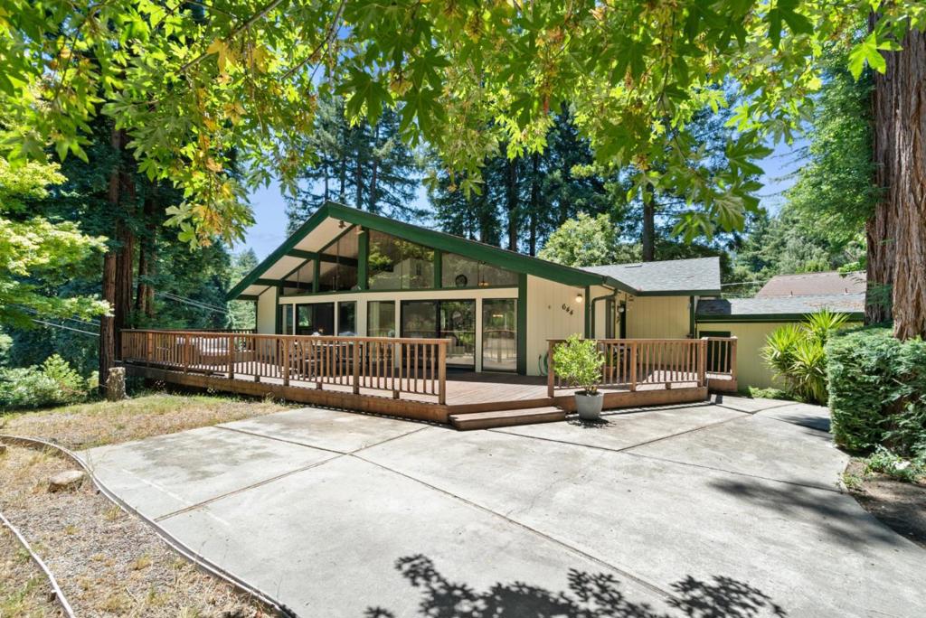 Live the Santa Cruz Mountain lifestyle without sacrificing comfort or convenience. Located just minutes from downtown Boulder Creek, this stylish 2 bedroom, 2 bath midcentury modern home invites you to soak up the serenity. With 1,789 sqft of single-level living, the open concept layout is bathed in natural light thanks to oversized windows and vaulted ceilings. Enjoy your morning coffee at the breakfast bar, host friends in the spacious dining area, or unwind on the large entertaining deck surrounded by nature. Recent updates include new flooring throughout and spacious quartz countertops. You'll appreciate the stainless appliances, pantry, central forced heating, ceiling fan, and an attic fan for year-round comfort. Set on a generous 9,932 sqft parcel with a detached 2-car garage, multiple decks, and generous gardening space, this home offers the perfect blend of indoor outdoor living. Hike nearby Big Basin trails, explore local parks, or head into town for coffee and community its all within reach. If youve been dreaming of redwood views, fresh mountain air, and a home that feels like a retreat, this is your moment.