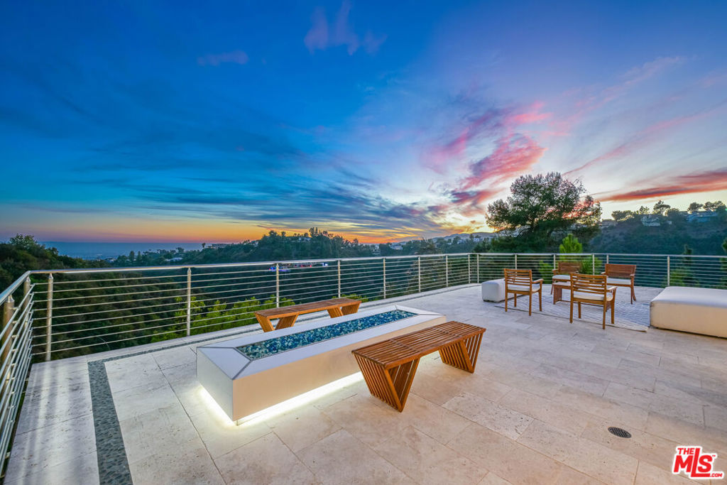 One of a Kind luxury home in the prestigious hills of Bel Air, this luxurious private residence boasts a harmonious blend of elegance and modern comfort. The expansive rear deck serves a a captivating centerpiece with impressive wide-ranging views encompassing the ocean, canyons, and breath-taking city lights.The property features a sparkling pool and a rejuvenating jacuzzi, perfect for unwinding under the California sun or the starlit sky.The dramatic entry, abundant with natural light, compliments strong architectural lines and open living spaces. A gourmet kitchen with custom countertops, kitchen island and stainless steel appliances. The main level is completed by an en-suite bedroom. The upper level is completed by five spacious bedrooms including a beautiful primary bedroom featuring a balcony, dual sinks and large walk in closet. Property is in high ranked Roscomare School District. SHORT TERM RENTAL & FURNISHED ALSO AVAILABLE.