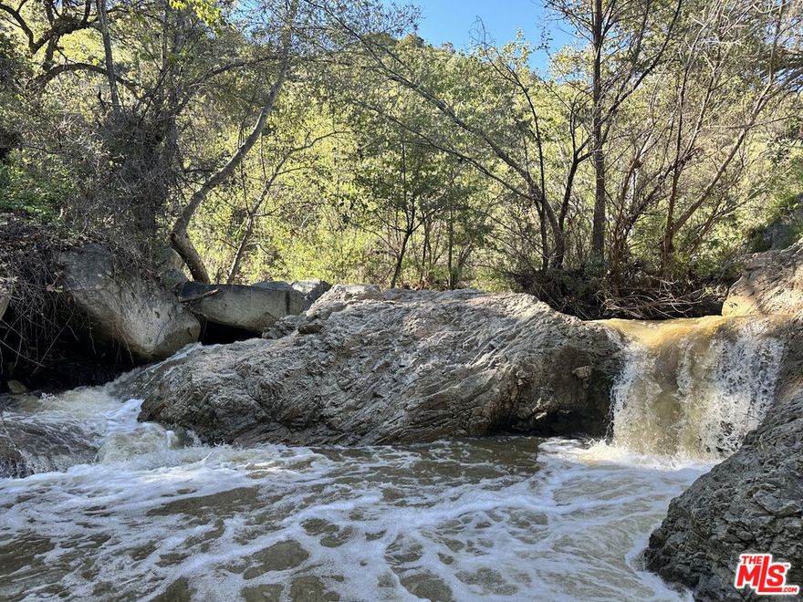 Discover extraordinary privacy and natural beauty on this 47-acre retreat in the scenic De Luz area of Fallbrook. This one-of-a-kind property features over half a mile of year-round creek frontage with waterfalls, granite rock formations, and shaded trails beneath mature oaks and sycamores. Improvements include multiple graded truck trails, several build sites, two established campsites, and a furnished glamping tent with solar power and Starlink internet. The land is zoned A70 agricultural and borders 1,200 acres of BLM land, offering ideal potential for a private estate, luxury retreat, or eco-friendly homestead. Enjoy panoramic canyon and mountain views, natural swimming holes, and complete seclusion just minutes from Temecula wine country and downtown Fallbrook. A rare opportunity to own a true California wilderness sanctuary with modern infrastructure and endless possibilities. Call LA to setup a showing.