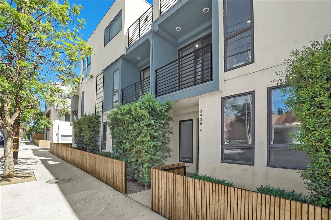 Built in 2016, this sleek and contemporary Silver Lake townhome offers 3 bedrooms, 4 bathrooms, and nearly 1,900 square feet of bright, open living space—just a half block from award-winning Ivanhoe Elementary and shops and eateries along Hyperion Avenue.
The entry-level features a private 2-car garage with direct access, plus a versatile bedroom with an ensuite bath—perfect for guests, a home office, or rental potential.
The second floor is an entertainer’s dream, boasting an open-concept living and dining area, a stylish kitchen with white shaker cabinetry, quartz countertops, stainless steel appliances, a walk-in pantry, and a center island. A powder room and balcony complete the space, creating a seamless indoor-outdoor flow.
Upstairs, you’ll find two spacious bedroom suites, including a sunlit primary with a walk-in closet and dual-sink vanity. A conveniently located laundry closet adds everyday ease. Other upgrades include recessed lighting throughout, tankless water heater, water softener.
Top it all off with your own private rooftop deck—ideal for soaking up panoramic city and mountain views, lounging with friends, or working from home under blue skies.