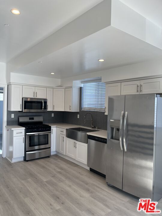 Experience elevated living in this beautifully designed 3-story townhouse offering panoramic city views and exceptional convenience. Nestled in a secure gated property, this spacious unit features 3 generously sized master bedrooms, each with its own private bathroom and large closets perfect - comfortable, independent living. Enjoy the ease and security of direct access from your private 2-car garage to your home, where you'll also find an in-unit washer/dryer hookup. The main & second level boasts an open-concept kitchen, dining, and living area with balcony - ideal for entertaining or relaxing plus a full master suite. Upstairs, two additional master suites await, including a private balcony where you can soak in sweeping cityscapes. Located just minutes from Hollywood, Larchmont Village, Griffith Park, and The Grove, this home places you in the heart of LA's most vibrant neighborhoods. With quick access to the 101 and 10 freeways, and surrounded by top restaurants and cafes, convenience is truly at your doorstep.Don't miss this rare leasing opportunity - luxury, location, and lifestyle all in one.