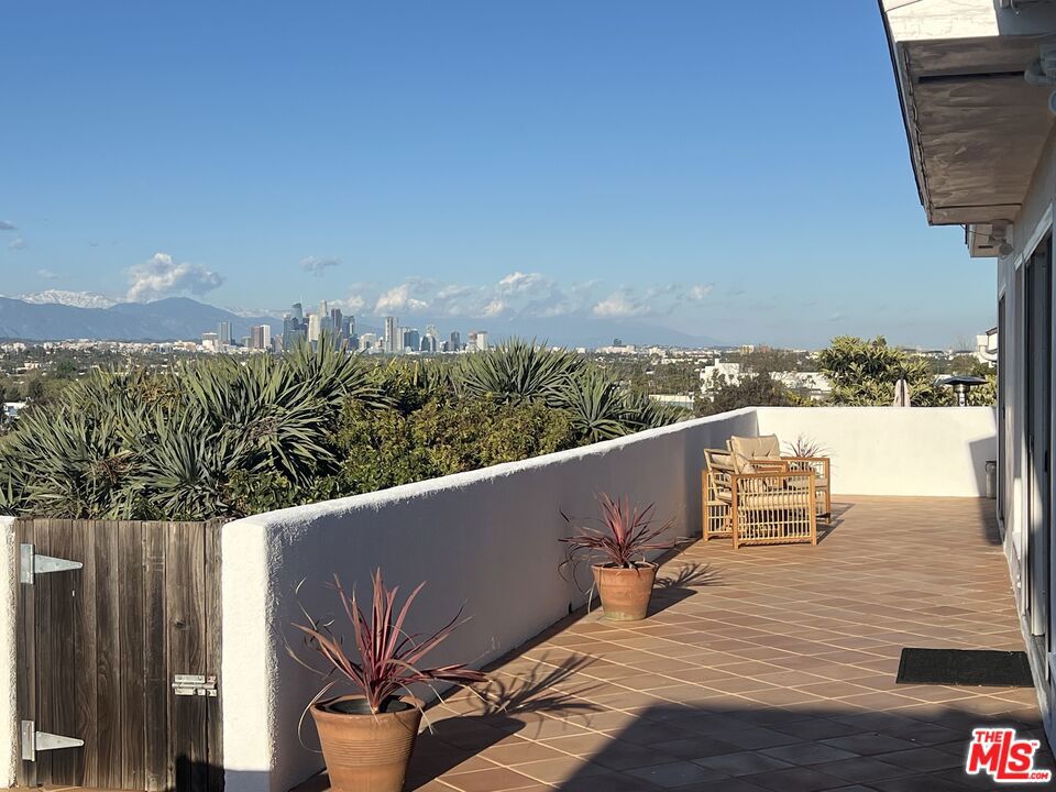 Beautiful Home with a Spectaular View from Century City from the west to Downtown, mountains and beyond from the east and the Hollywood sign from the north!! Light ,airy and bright with views from every room .Updated kitchen with new appliances and flooring and updated bathrooms. livingroom with fireplace. Hardwood floors throughout the home and lots of windows to capture the VIEWS. Also have a Master Suite, like being on vacation everyday! Huge expansive deck for outdoor living and entertaining, all on an over 8,000 sf lot.