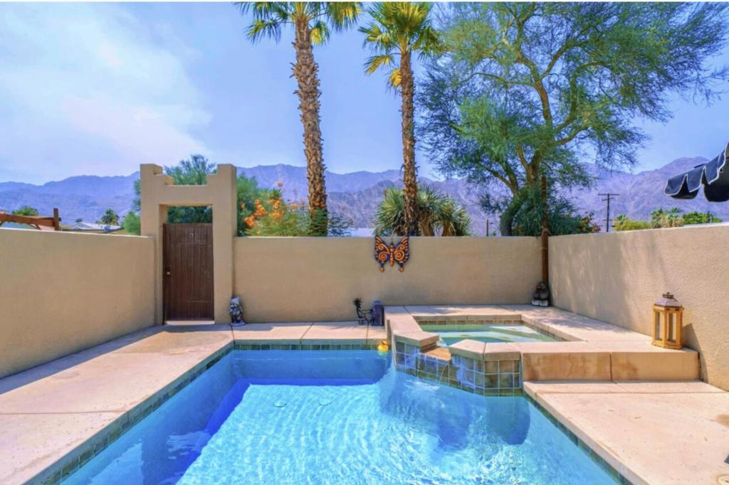 Nestled in the La Quinta Cove with dramatic mountain views, this beautifully appointed 3‑bedroom, 2‑bath delivers the perfect desert lifestyle getaway. Built in 2005 with approx. 1,929 sq ft, this Santa Fe‑style residence exudes excellent curb appeal, with its dramatic clay‑tile roof, gated private courtyard, and lush desert landscaping.Step through the courtyard into an entry that flows into a spacious living space with a cozy fireplace, soaring high ceilings, and an open great-room floor plan that seamlessly connects to the updated kitchen and dining area--perfect for entertaining or everyday living. Light fills the adjacent family room, creating an ideal gathering space for family or guests.Recent upgrades include new carpeting, a new A/C system, new hot water heater, and a new garage door and opener--plus the home comes with washer, dryer, and refrigerator included for added convenience.Outside awaits a private pool & spa oasis, perched to capture sweeping views of the Santa Rosa Mountains--imagine relaxing in the spa or unwinding poolside at sunset, with the dramatic desert landscape as your backdrop.Location is exceptional: just a short stroll or quick drive to Old Town La Quinta, where you'll find boutique shops, delightful dining, and vibrant weekend events. Fritz Burns Park, just minutes away, offers courts for pickleball, tennis, swimming, plus playgrounds and open lawn space. Outdoor lovers will appreciate immediate access to the Bear Creek Trail, with scenic hiking and biking trails through the La Quinta Cove landscape.This home strikes the perfect balance of modern comfort and true desert charm, with its open‑concept layout, abundant natural light, mountain vistas, and rich blend of indoor-outdoor living.