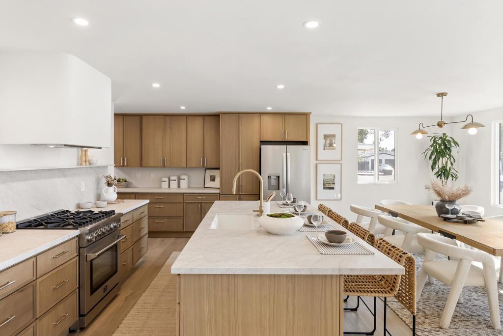 A Designer’s Dream – Now the Best Value in Bay Ho! Now priced $15,000 lower and offering the best price per square foot for a home this size in Bay Ho! This stunning 4-bed, 3-bath residence is a custom-caliber renovation that redefines luxury living. Every inch has been thoughtfully curated—from wide-plank flooring to hand-selected fixtures and finishes—this is not your average flip. The heart of the home is a magazine-worthy kitchen featuring dual sinks, a built-in coffee station, wine fridge, and abundant custom cabinetry. An oversized island anchors the open-concept layout that flows effortlessly between kitchen, dining, and living spaces, all bathed in natural light. Upstairs, the expansive primary suite feels like a boutique hotel, with a spa-inspired bath, generous closet, and private balcony. All bathrooms are elevated with timeless finishes and smart functionality. Each bedroom offers flexible space for guests, work, or family needs. Outdoors, enjoy a peaceful fully fenced yard with mature fruit trees, room for dining, and space to add a small pool. Nestled in the heart of Bay Ho, this home blends tranquility with top-tier design—and now, unbeatable value.