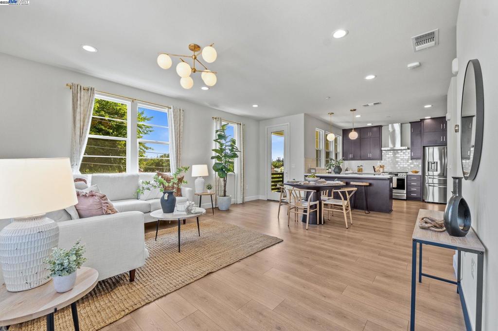 The one you've been waiting for! This lovely unit is tucked in a quiet corner of the community * As an end unit, the corner windows provide an abundance of natural lighting throughout * The modern floor plan features a suite on the 1st level, providing privacy for guests, or as a home office * All bedrooms have full baths ensuite * The 2nd level offers an open concept great room, featuring West Elm lighting, made-to-order window coverings & a private patio with views of the hills * The gourmet kitchen features high-end appliances (gas cooking!), plenty of counter space, quartz counters & a full size pantry! Waking up in the sunny primary suite will start your day off right with its generous size, amazing natural light, tall ceilings, walk-in closet + spa-inspired bathroom with tile floors & quartz finishes * A laundry nook is conveniently located on the 3rd floor; the Wi-Fi enabled washer & dryer are included! Each floor has its own climate control (both heating & cooling) * Other notable features: 2-car garage, tankless water heater & several smart home devices (Yale lock, Nest thermostats, MyQ garage controls) * Excellent location! Walkable to shops & restaurants; near Quarry Lakes, Lake Elizabeth, Central Park * Commute with ease via 880, 84, ACE Train, BART. Open Sat/Sun 1-4p