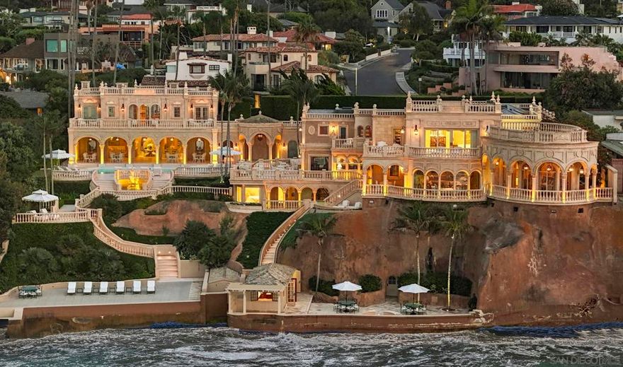 The Sand Castle is La Jolla's most iconic waterfront jewel and includes one of the only on-property private beaches in California. A stunning homage to the finest manors on the French Riviera, the inspired and meticulous elegance of the Main House, Guest Residence and expansive grounds provides magnificent living while honoring extraordinary unobstructed views of the Pacific and coastline to the west, north and south. European and bespoke interiors and exteriors perfectly meld with modern conveniences, deftly designed and curated by global interior design icon, Timothy Corrigan. A tone-on-tone palette mirrors the sea and sky while continually orienting the visitor towards the home's dramatic ocean views. No expense was spared in creating The Sand Castle. Multistory, manicured hedges cocoon the property, and upon entry through the magical courtyard and grand front hall, one is called to the water. Private and secure, luxurious and serene, The Sand Castle evokes the most sumptuous of grand hotels, with solid gold gilded rooms, a Thassos-tiled salt-water pool, extensive terraces and patios, an elevator, two marvelous cabanas, fitness center, spa, bespoke statues and chandeliers, firepit, boat bar, and a host of private spaces in which to observe the rolling waves and experience dramatic sunsets.  The Sand Castle is truly one-of-a-kind and can never be replicated.