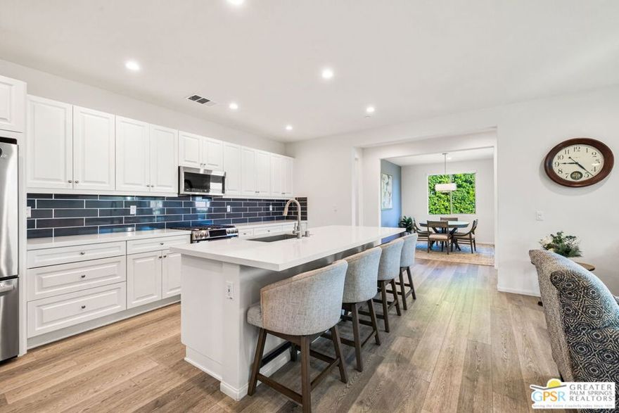 Step into one of this highly upgraded and thoughtfully designed Reunion plan located within the Trilogy Polo Club by Shea homes. Immaculate and loaded with premium, designer selected upgrades, this home immediately impresses from the moment you enter. The chef's kitchen is designed to impress, featuring GE Profile appliances, shaker style dovetail soft close cabinets, quartz countertops, an undermount sink, an expansive island, and a custom designer backsplash. Porcelain tile throughout the main living areas offers lasting durability and effortless maintenance, ideal for pets and grandkids alike.The thoughtfully designed layout places the second bedroom on the opposite side of the home, enhancing privacy for guests or family members. . A third bedroom option and is currently used as a spacious home office.  A covered back patio finished with pavers and enhanced by electronic drop down sunshades creates an ideal setting for year round indoor outdoor entertaining. The backyard is beautifully curated with artificial turf, plumeria plants galore, and tall ficus trees that provide exceptional privacy with no homes directly behind you. Additional highlights include an extended garage two feet longer than standard, a space saving tankless water heater, and a versatile SmartSpace combining laundry and storage away from the main living areas, solar. With upgraded flooring, custom blinds, and thoughtful enhancements in every room, this home is truly immaculate and showcases exceptional pride of ownership, one you need to experience in person to fully appreciate.