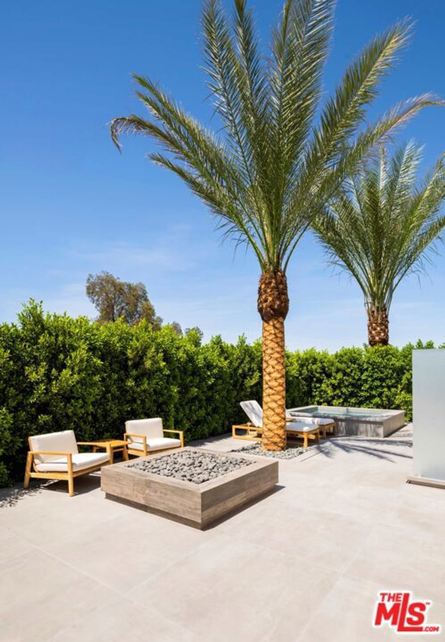 Stunning new and private warm contemporary with explosive golf and mountain views on one of the best streets in the ultra desired Madison Club. Top of the line design and construction and that special world class interior design touch that makes instant magic happen and gives you goose bumps as you walk in and imagine the life style experience this property would surely provide it's future very lucky owner. The perfect open floor plan with more than 13,000 SF under roof and Approx. 9,400 SF under A/C boasting a total of 9 beds (6 bedroom suites) including an approx. 1,800 SF 2-bedroom guest penthouse with fireplaces and mountain views, a killer cinema, Italian main kitchen and chef kitchen, a bar area, 3 car garage and an additional golf cart garage all tiled and with RGB lighting, shaded car port and large and gated motor court, a zero edge oversized pool with a large built in fire pit area, covered patio and loggia with 4 different sitting areas, outdoor living room with a fireplace, extensive BBQ area, a private master patio with a spa, outdoor shower and a fire pit, and one of the nicest closets/bath combos out there. A massive sound system fills the spaces with warm and fuzzy bass and perfect frequencies and 16 TV's plus one 210" screen deliver perfect images of the many Apple TV's around. Top of the line home automation and control and the most efficient AC system available today modulating up to 26 SEER joining the solar system of the house in maximizing future savings. Sold furnished and including 19 abstract art pieces curated especially for the property. And yes full sun on the pool and full shade on the covered patio all day...every day...weekends and winter included.