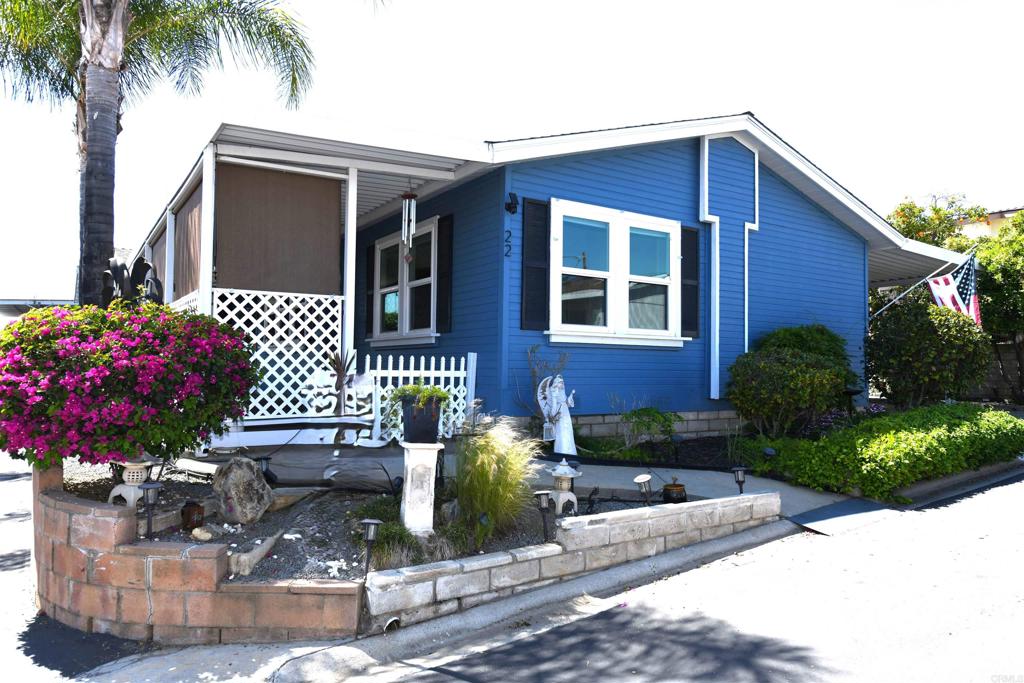 Rare Opportunity...Foothills of San Marcos 55+park. Whether you have a need for a multi family or extended family layout, need to share your home with a caregiver or simply want a larger home, this home is for you. This wonderful home has two bedrooms and a bath on one side of the home which has a large living room with a cozy fireplace and built in wet bar. The other side of the home has a large family room with a built in hutch and dining area. Primary bedroom with a walk-in closet and a good sized tastefully done primary bath. Open Kitchen with breakfast bar and big enclosed pantry. Indoor laundry area with additional refrigerator. Home has wheelchair access to carport and front patio area. Newer roof and updated dual HVAC systems with smart thermostats. Outside comfortable patio to enjoy outdoor entertaining often with delightful breezes. Workshop shed and another shed for storage. Home has PAID solar with an electric car charger hookup. Current owner has been paying $0 for electric bill. AMAZING SAVINGS! Park offers a clubhouse with frequent activities, billiard room, card rooms, pool, spa, tennis, dog park and HOA includes cable with HBO plus additional monthly credit towards electric bill and more! RV parking available for a minimal charge.
