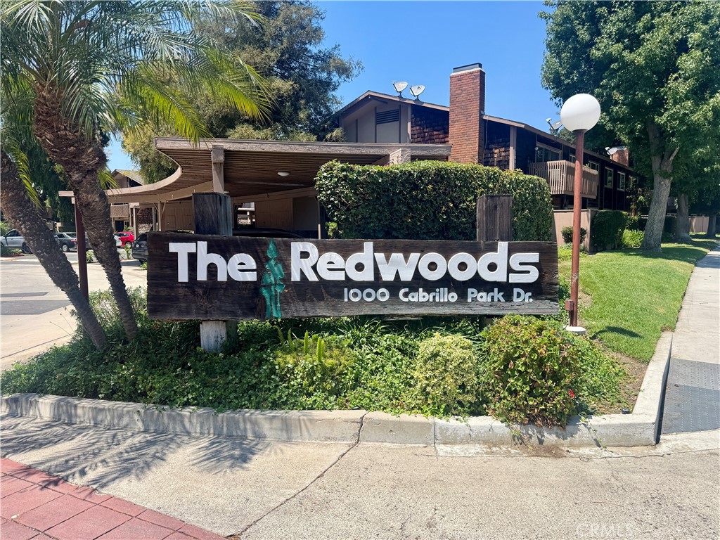 Welcome to unit G at 1090 Cabrillo Park Drive, located on the second floor of The Redwoods in Santa Ana. This top-floor condo offers 943 square feet of living space, featuring 2 bedrooms and 1 bathroom in a convenient, central location. Inside, the main living area features an open floor plan with laminate flooring throughout, complemented by an upgraded kitchen connected to a dedicated dining area perfect for entertaining and everyday living. The kitchen has been modernized with Cleaf laminate cabinets, quartz countertops, and a walk-in pantry for ample storage. The primary bedroom includes a walk-in closet, and the full bathroom has been recently renovated. The unit is enhanced with crown molding, recessed lighting, and a patio ideal for barbecues and enjoying sunny days. The nearby laundry room is easily accessible, and the unit comes with an assigned carport space and a parking permit for additional parking. This community also offers access to two pools, a jacuzzi, a clubhouse, and a gym. Come make this semi-furnished unit your next home.