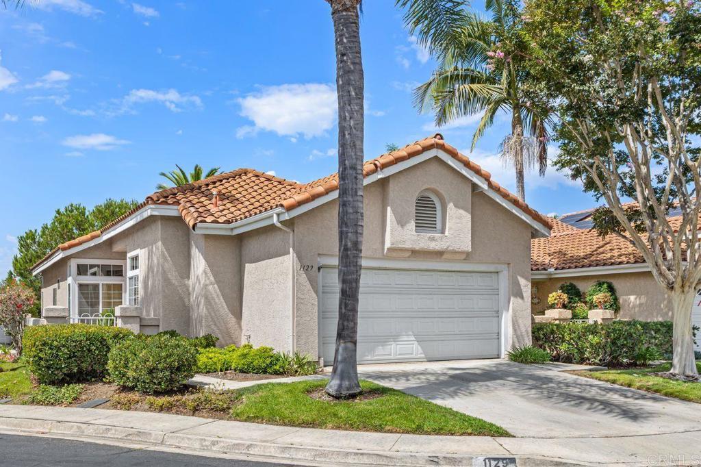 Welcome to this lovingly maintained single story home in the highly desirable Lido community of Shadowridge! Offering 2-bedrooms plus a den, 2-bathrooms, and 1,420 sq. ft. of comfortable living space, this home is situated on an elevated lot in a cul-de-sac and features a gated courtyard. Upon entering the home, you will be welcomed by an abundance of natural light streaming through the windows along the entire back of the home. The expansive living room boasts a cozy fireplace and breathtaking views of the backyard, while the adjacent dining room offers plenty of space to entertain and enjoy the same scenic backdrop. The eat-in-kitchen boasts granite countertops and stainless steel appliances. The den is located near the entrance to the home and could be great office space or even an optional 3rd bedroom. The primary bedroom features a slider out to the backyard and the en-suite bathroom has dual sinks and a walk-in shower. The private backyard features low-maintenance turf, a covered patio that runs the length of the home, and beautiful views overlooking the neighborhood. Other features of the home include a full-size laundry room and 2 car attached garage. The Lido community offers fantastic amenities, including two pools and spas with HOA-covered front yard landscaping and common area maintenance. With quick freeway access to the 78, this home is located approx. 8 miles from the beach and is within close proximity to shops, restaurants, schools, and the beautiful Shadowridge golf course. Nature lovers will appreciate being about 1 mile from Buena Vista Park Pond & Open Space where you can feed the ducks, walk the dog, or enjoy the scenic hiking trails. This home offers the perfect blend of comfort, convenience, and community. Don't miss out—schedule your private showing today!